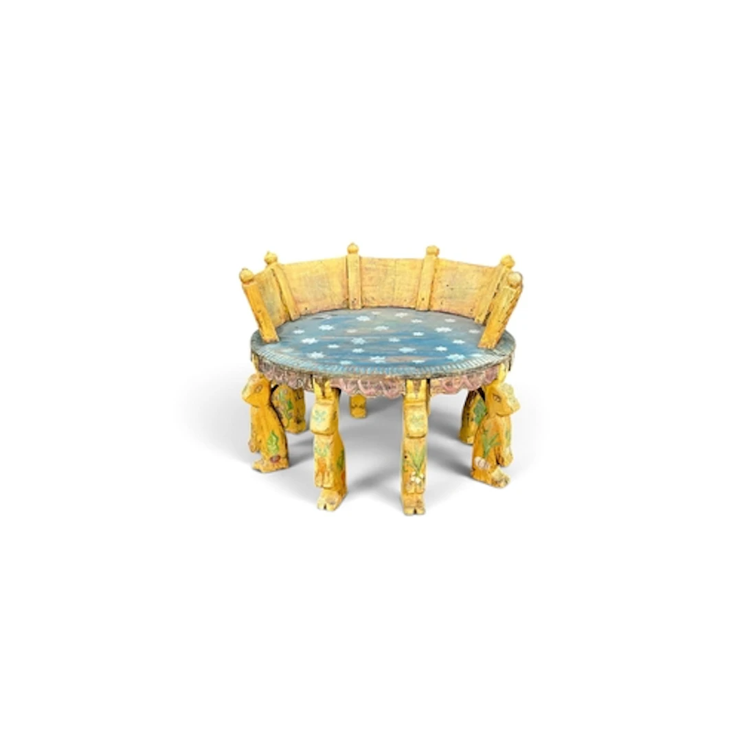 AN INDIAN CARVED AND PAINTED STOOL The circular top of plank...