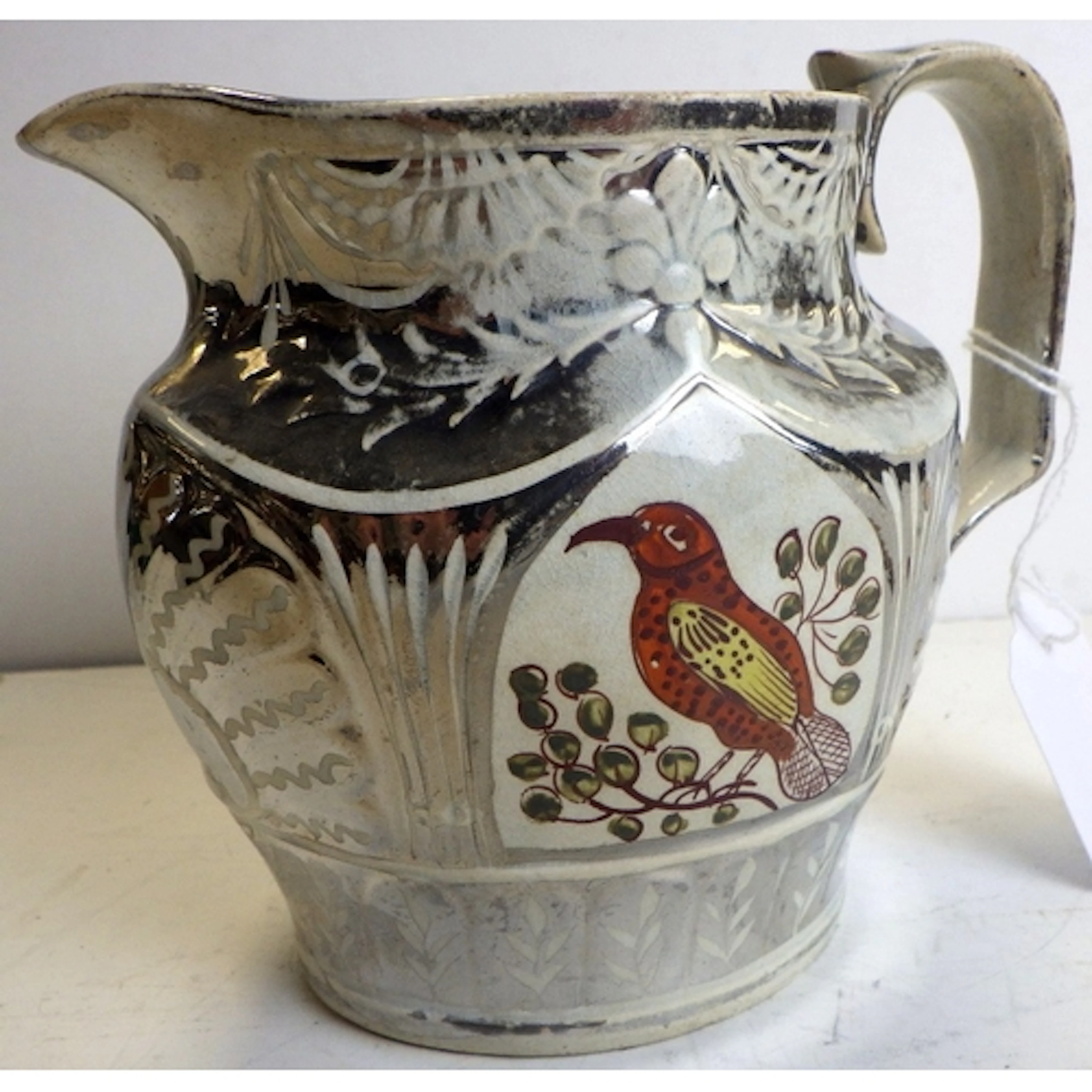 A silver lustre pottery pitcher, early 19th century, with en...