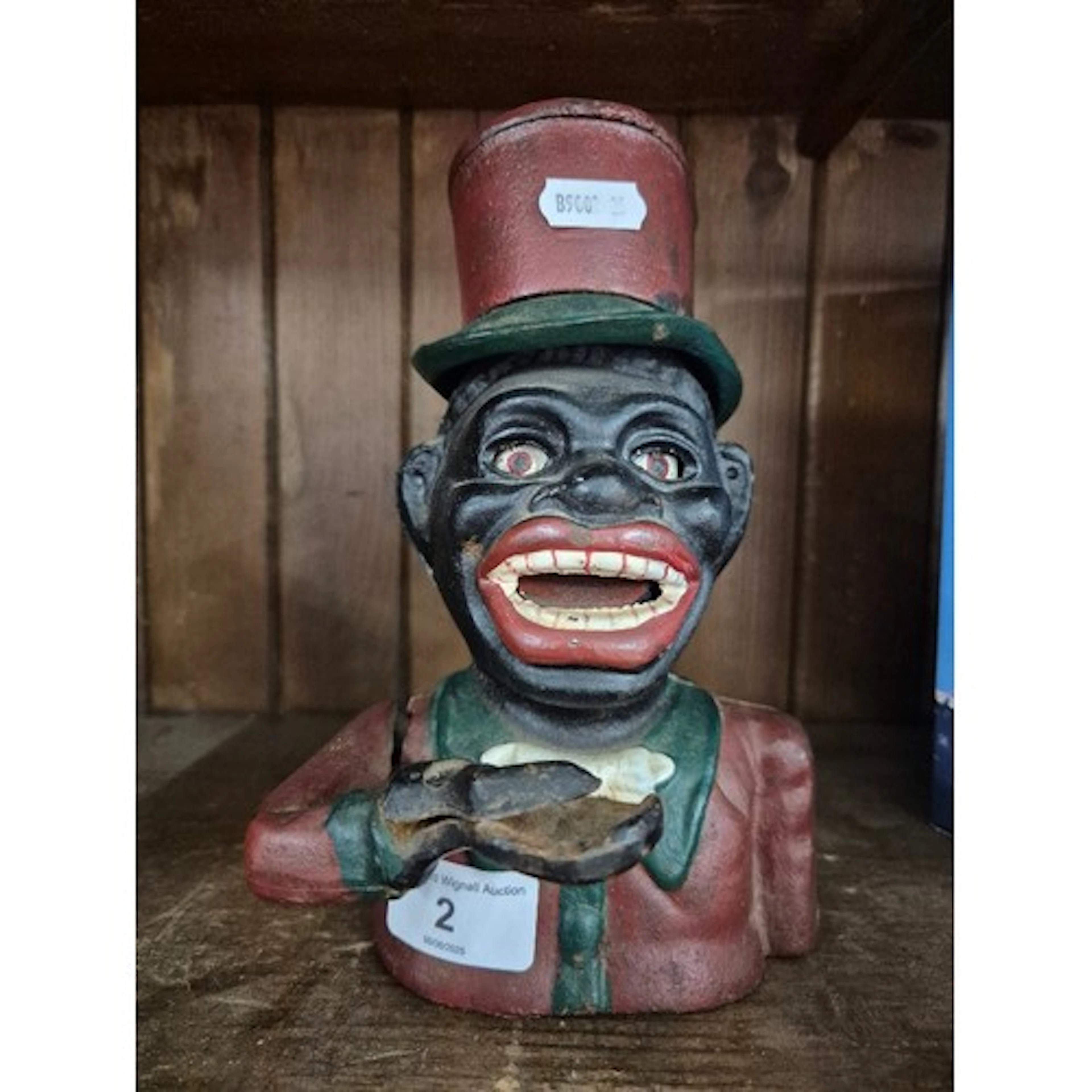A cast metal mechanical money bank. Note:- These items are ...