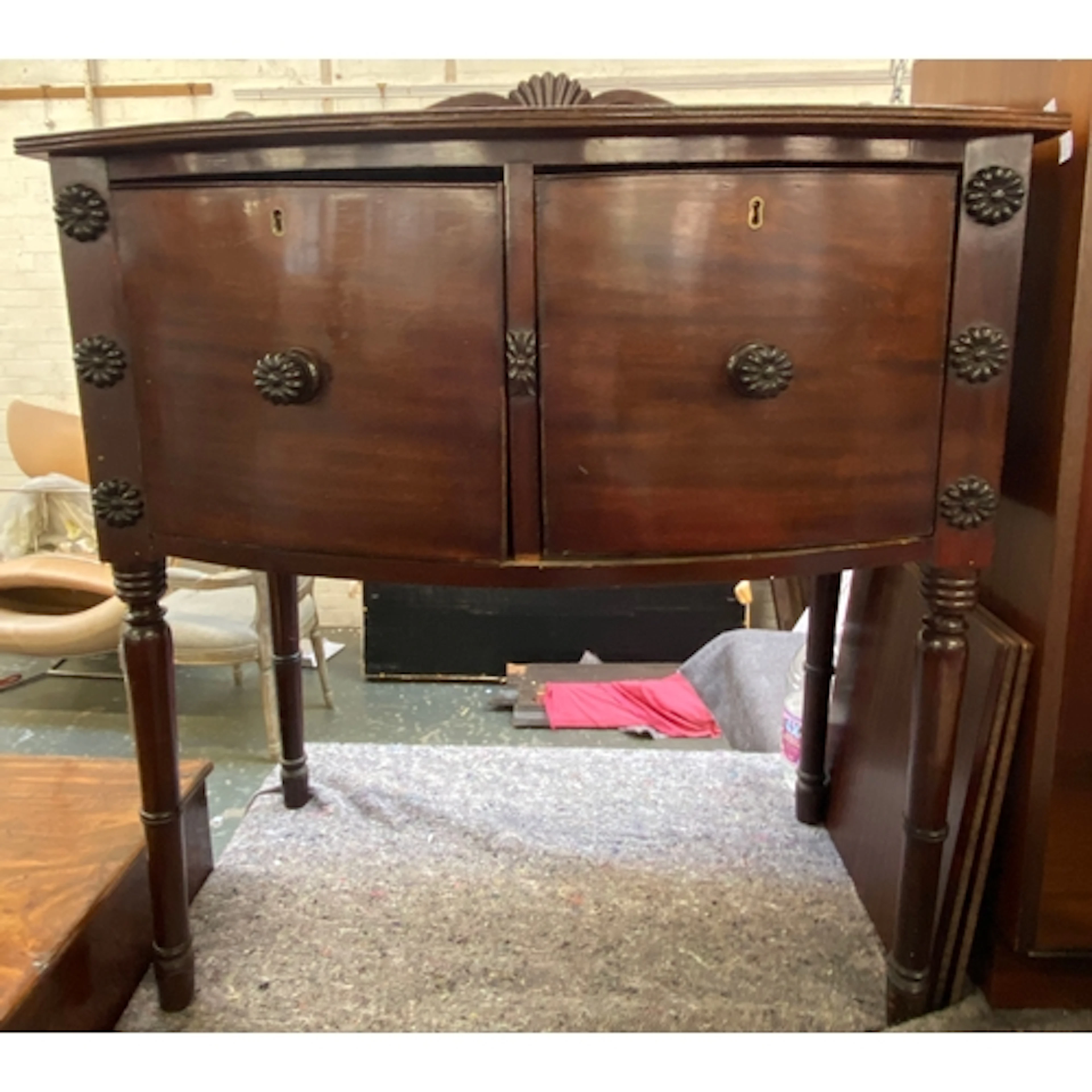 A late 19th century bowfront cottage sideboard with two deep...