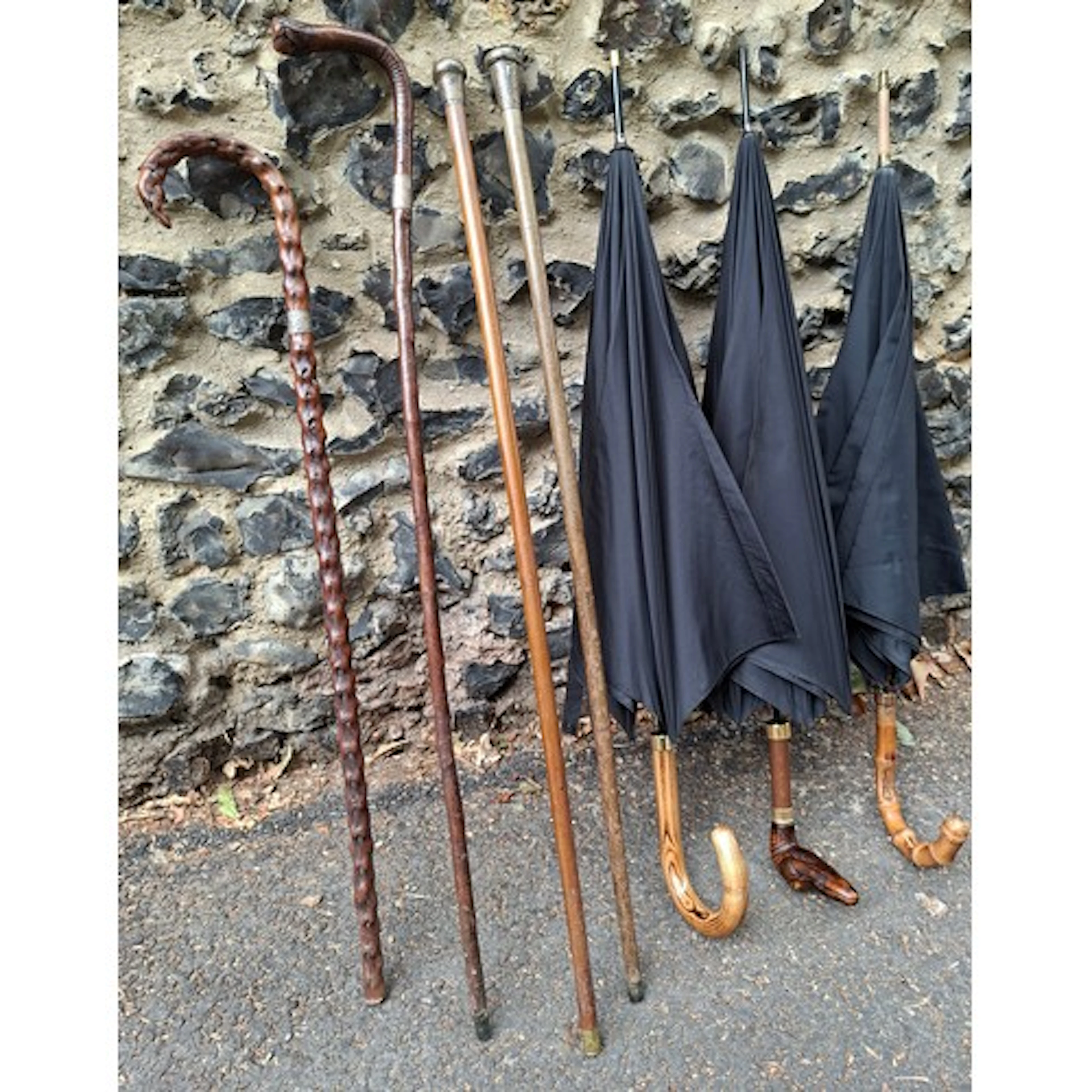 A Telman black umbrella having a 9ct rolled gold band above ...