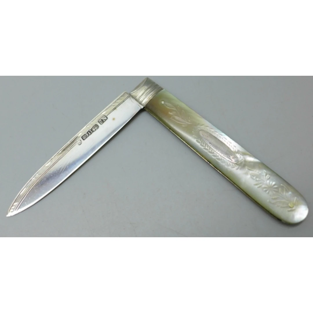 A carved mother of pearl fruit knife with a silver blade, Sh...