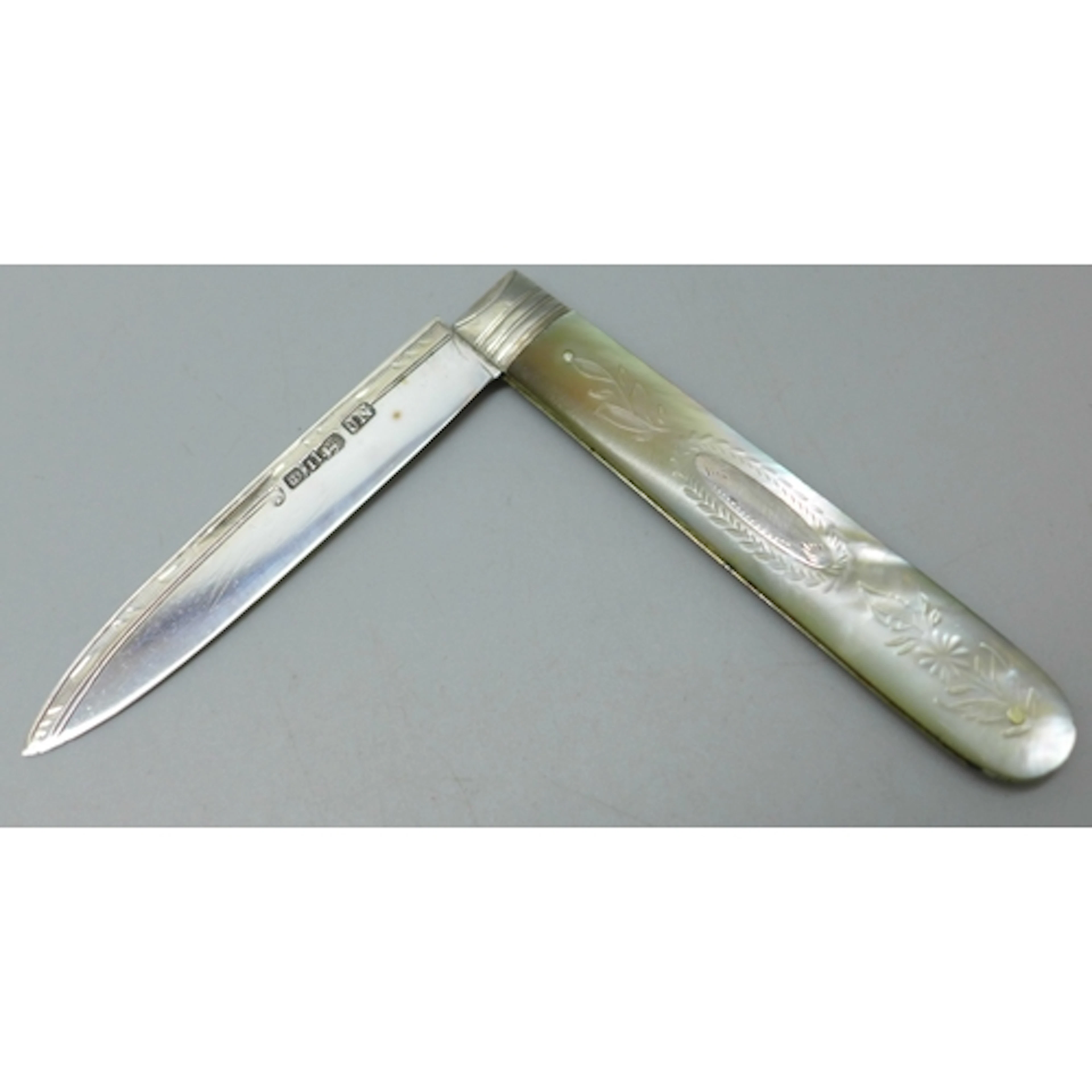 A carved mother of pearl fruit knife with a silver blade, Sh...