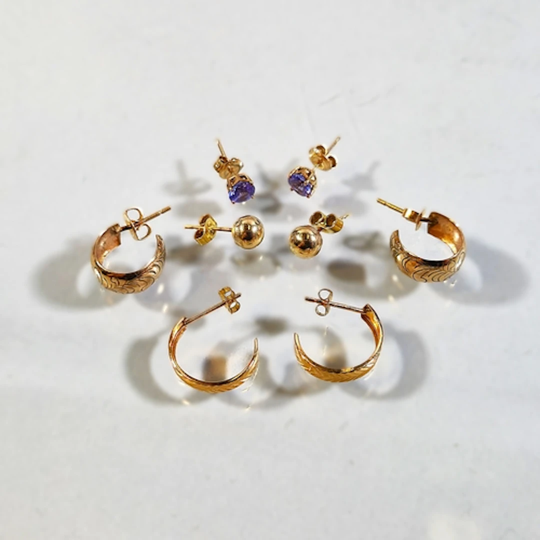 Pair of 14k gold hoop earrings, 1.3g gross, with pair of sim...