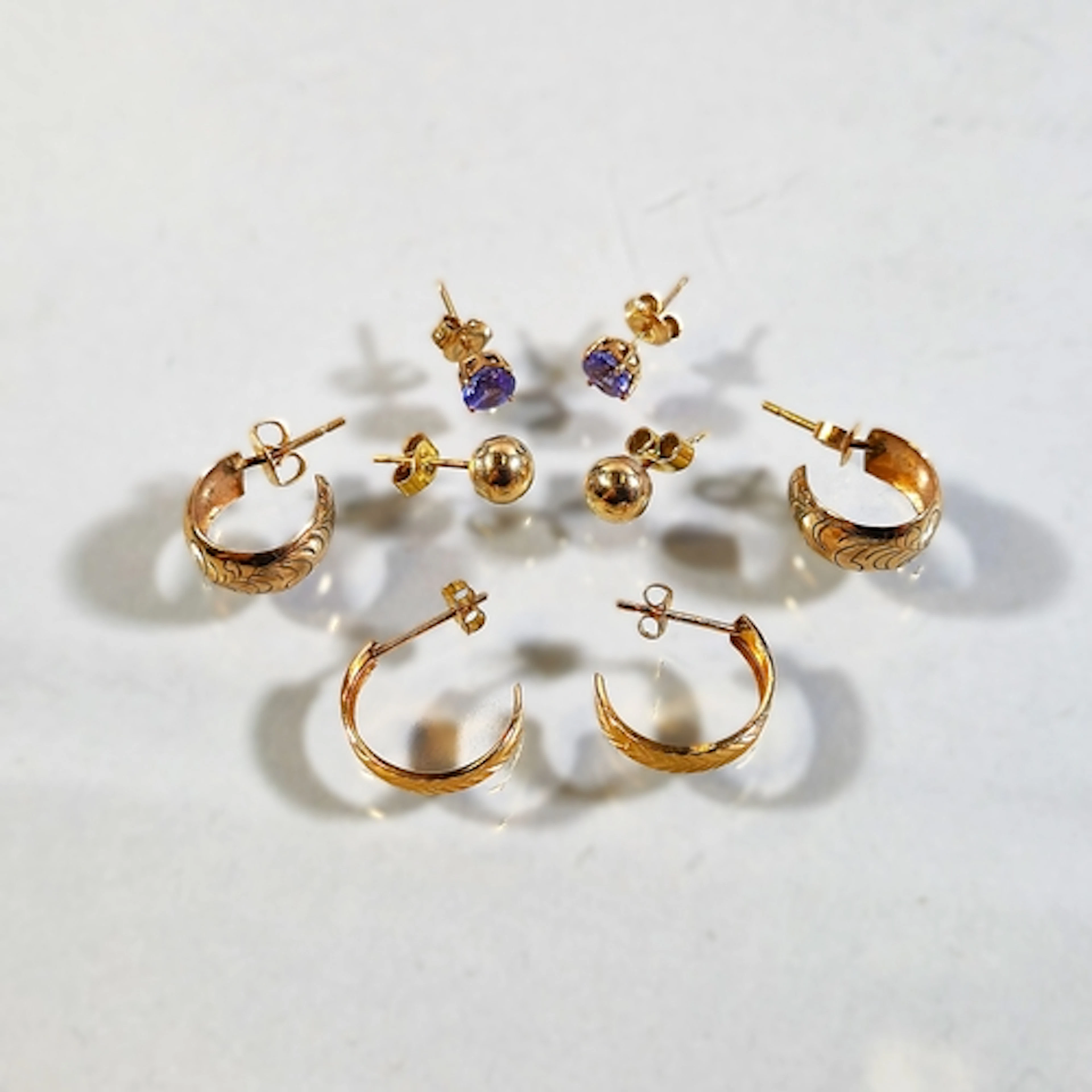 Pair of 14k gold hoop earrings, 1.3g gross, with pair of sim...