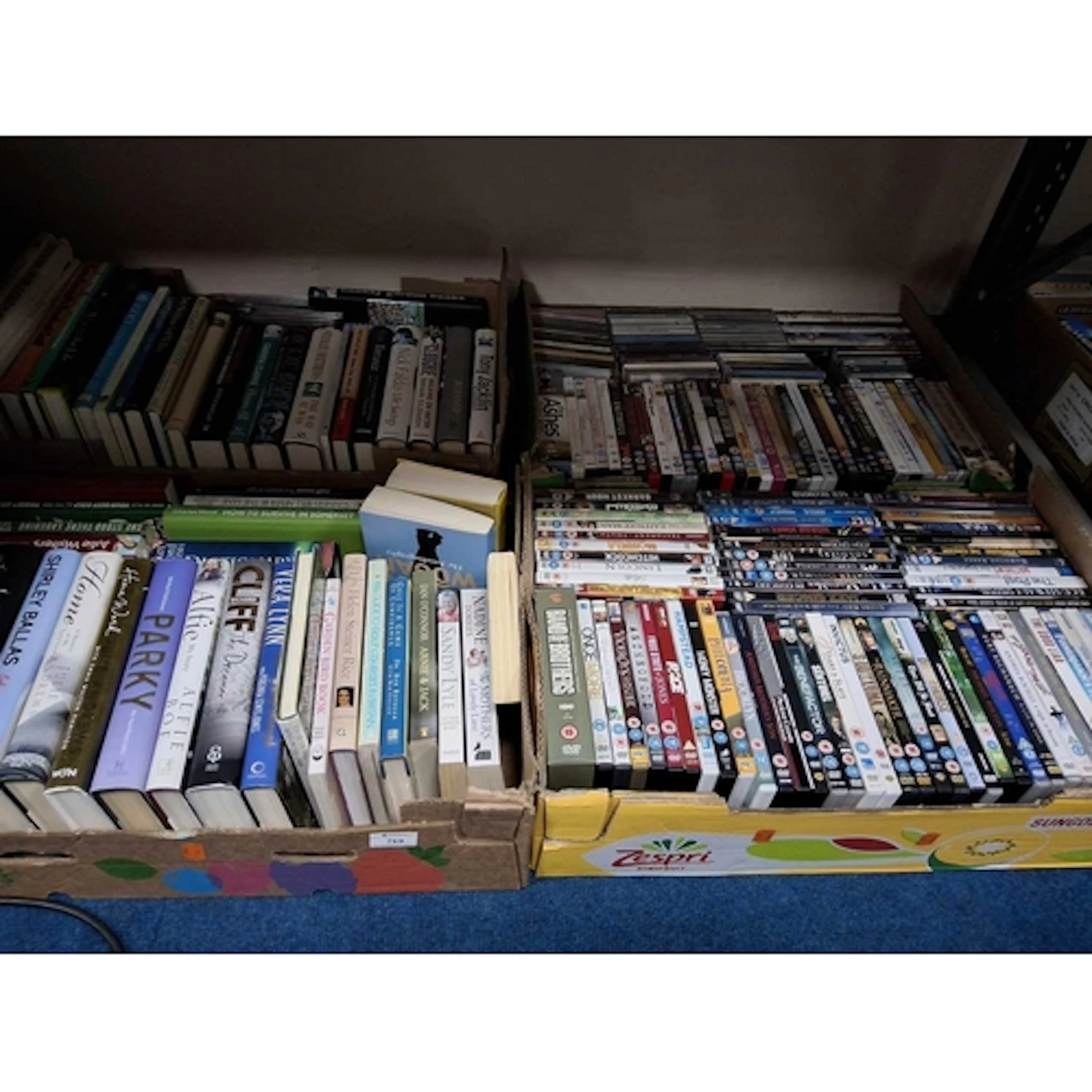 FOUR BOXES CONTAINING MOSTLY BOOKS AND DVDS, the majority of...