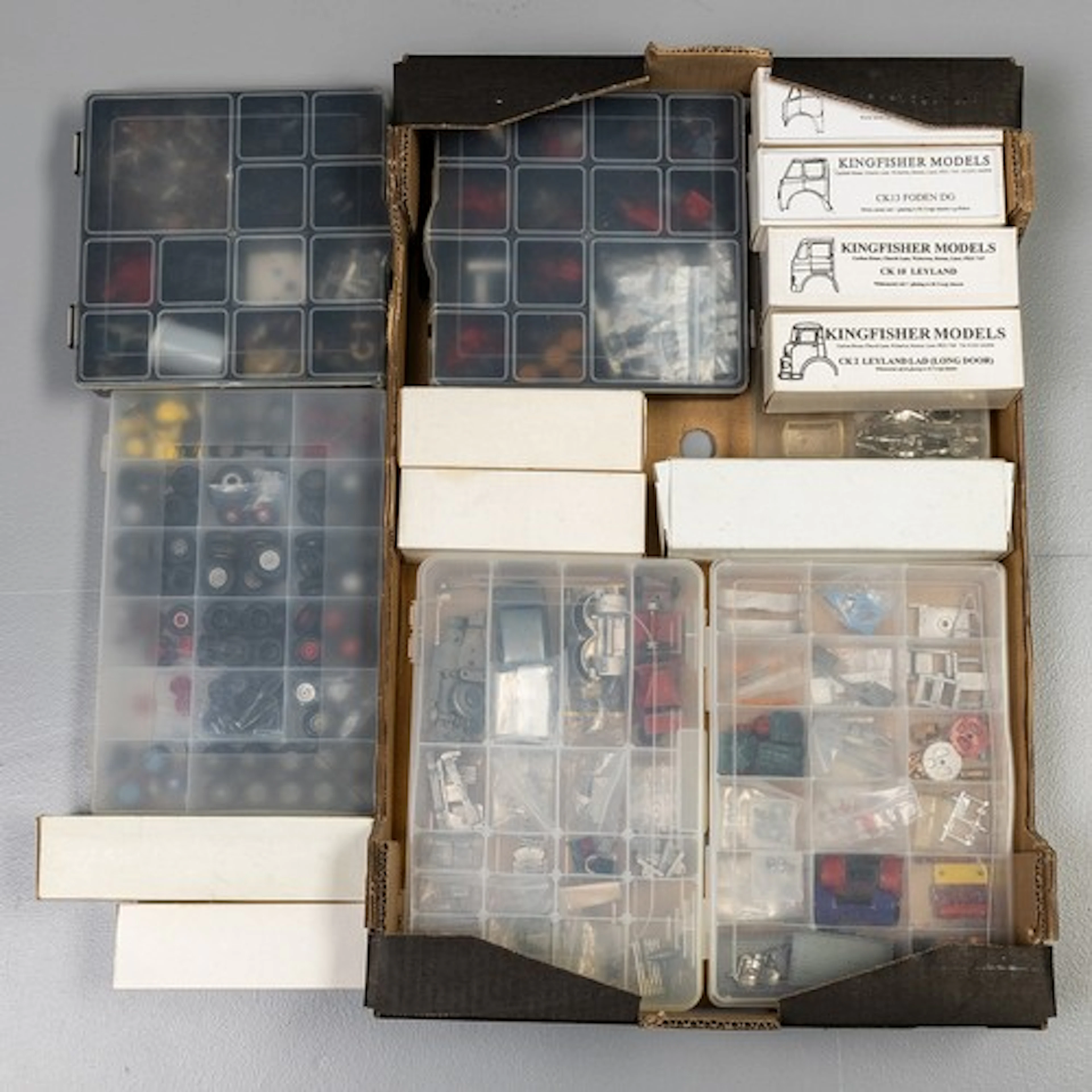 Fruit tray containing Dinky/Corgi spares for restoration wor...