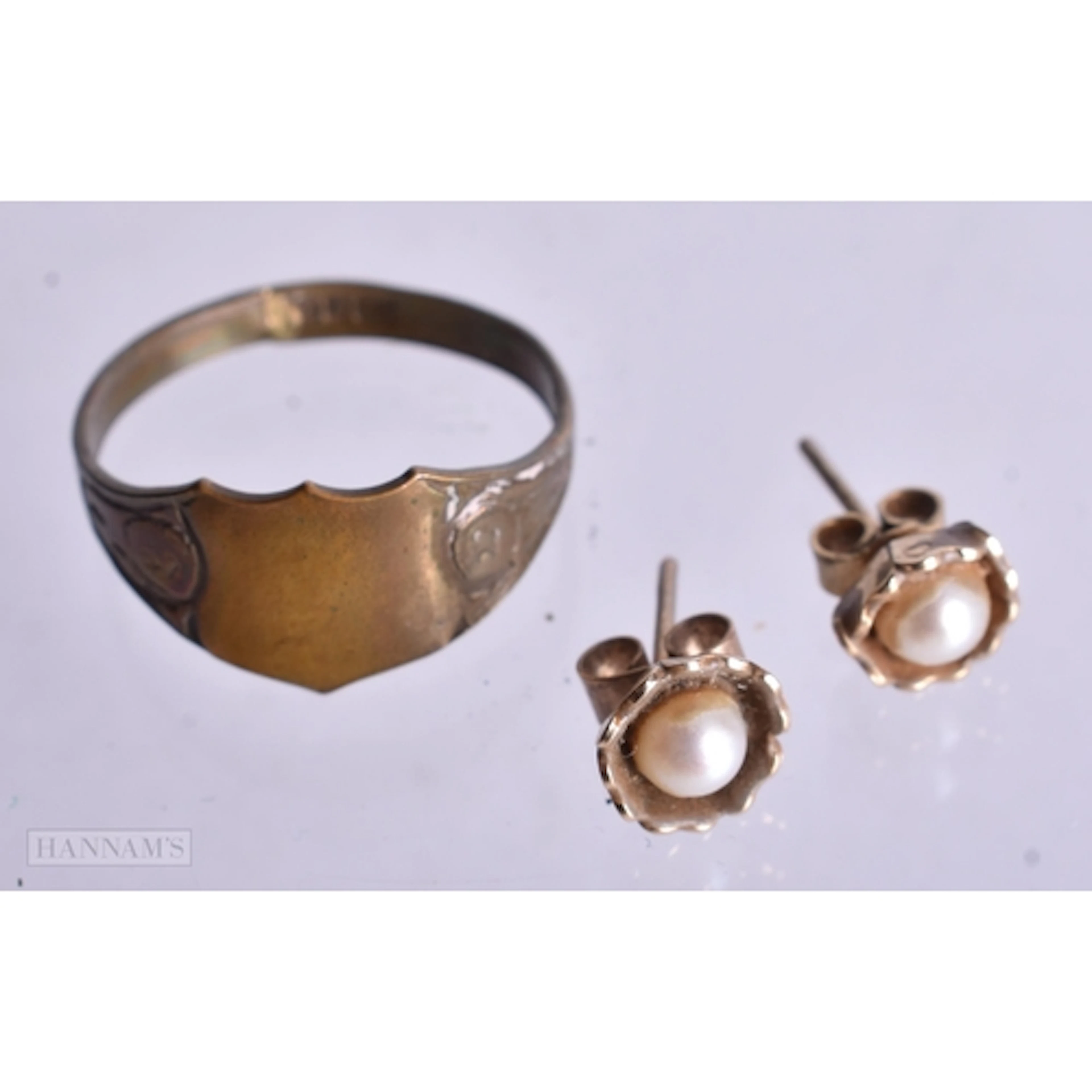 A PAIR OF 9CT GOLD PEARL EAR STUDS and a yellow metal ring. ...