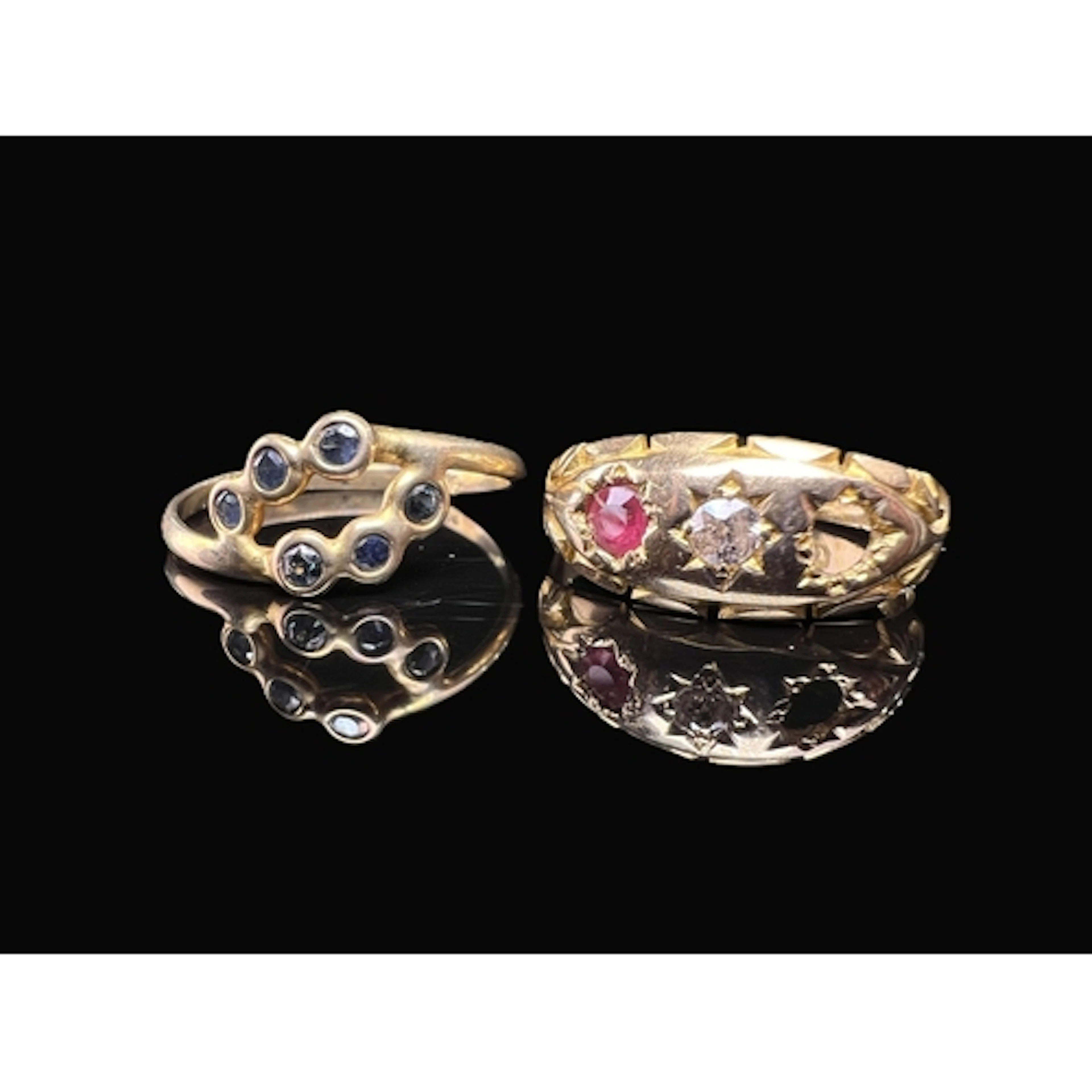 An 18 carat gold dress ring with central diamond flanked by ...
