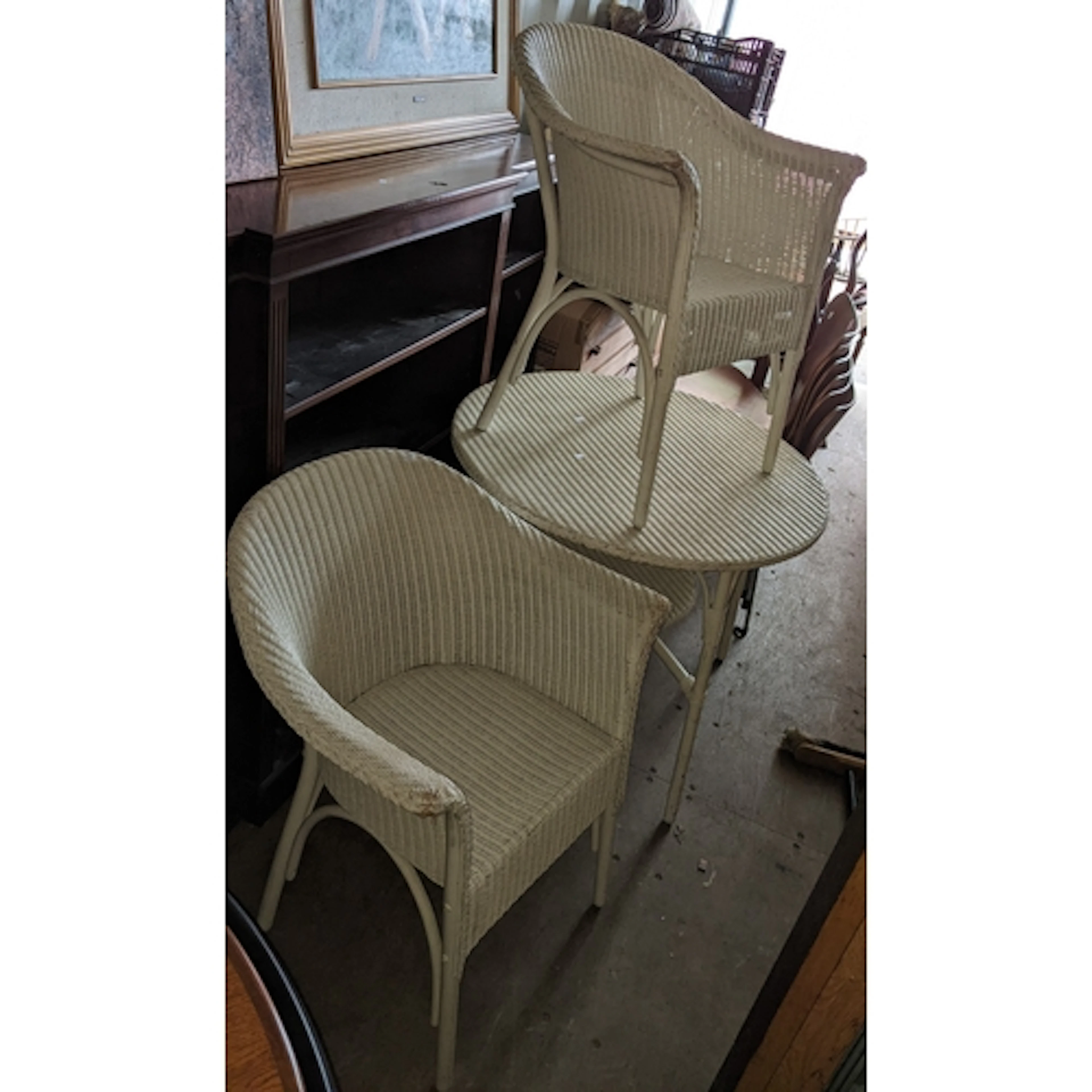 A white Lloyd Loom circular two tier table, 71cm h x 90cm w,...