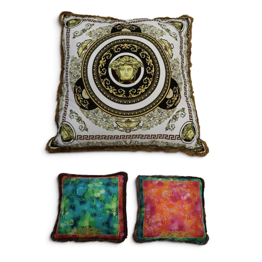 A large Versace cushion in Greca pattern with medusa head; t...