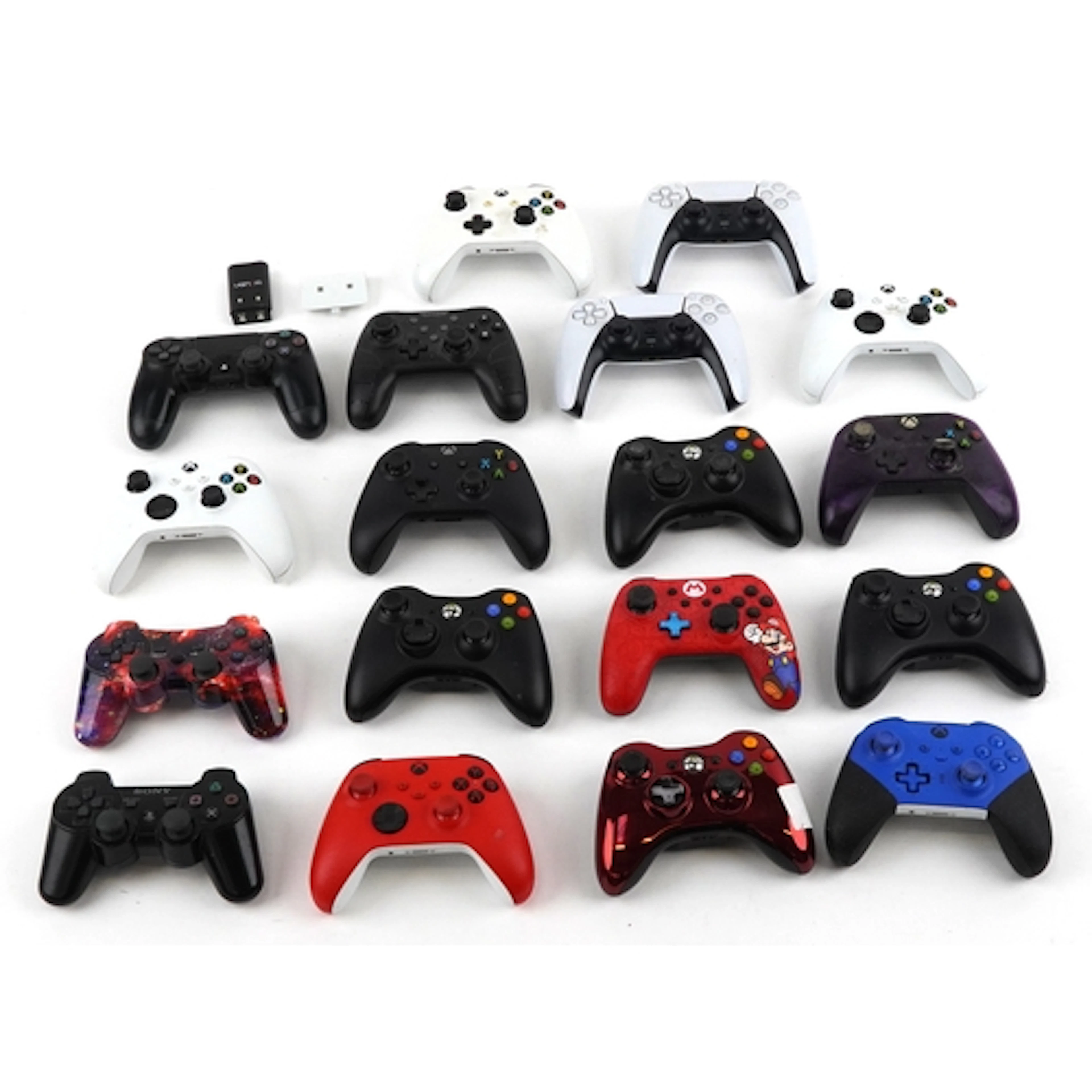 Collection of games console controllers including Sony PlayS...