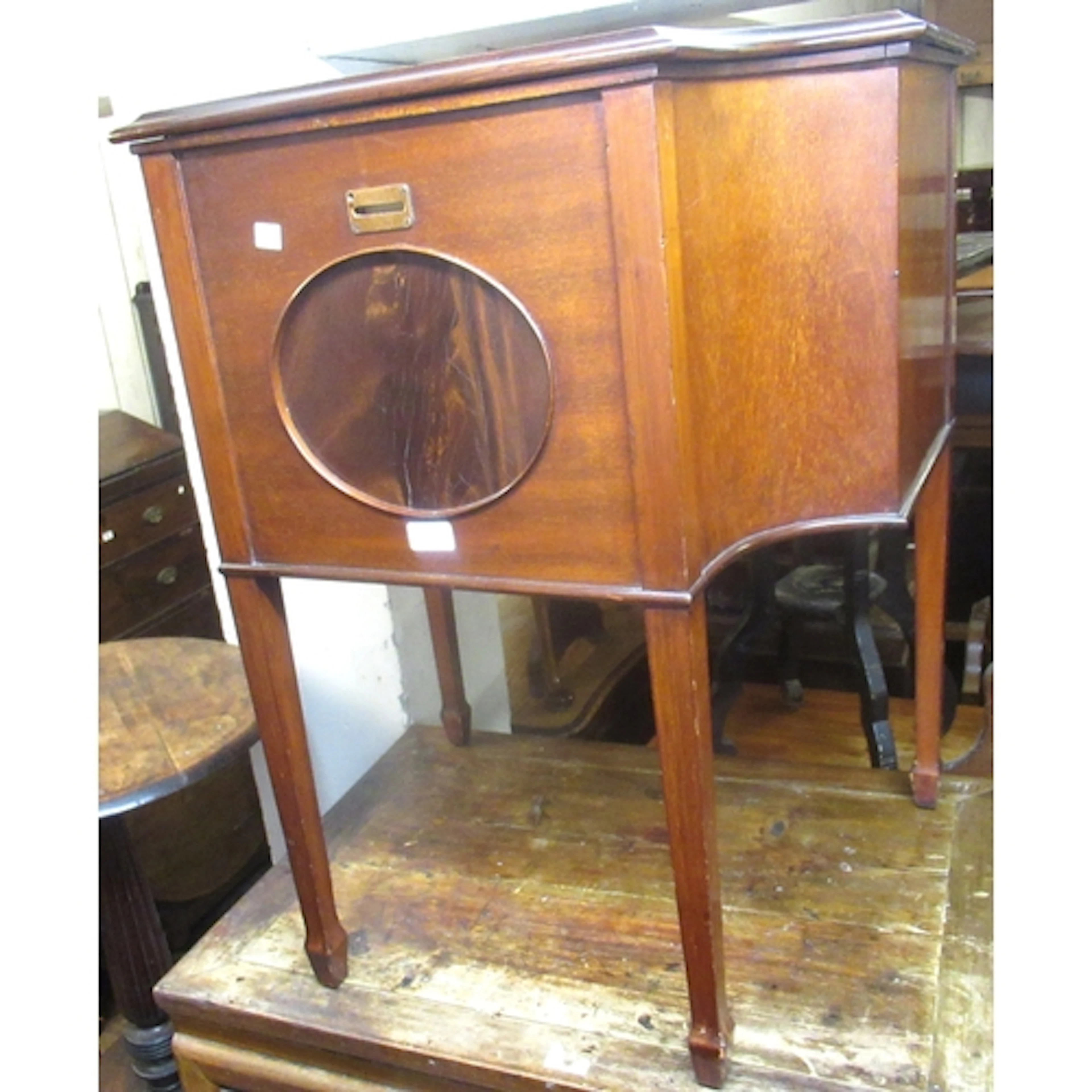 Early 20th Century mahogany drinks cabinet, the shaped bi-fo...