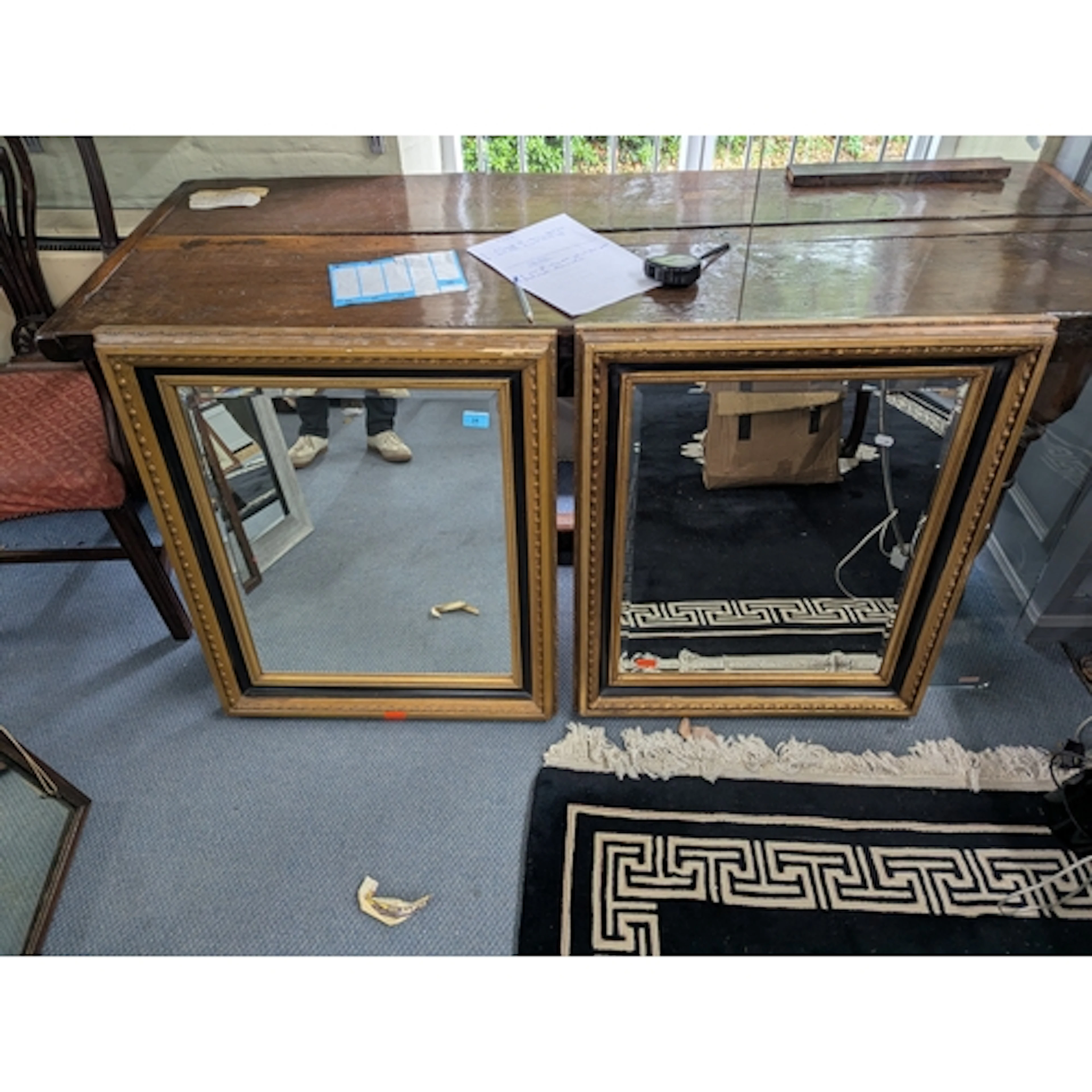 A pair of early 20th century gilt and black painted framed m...