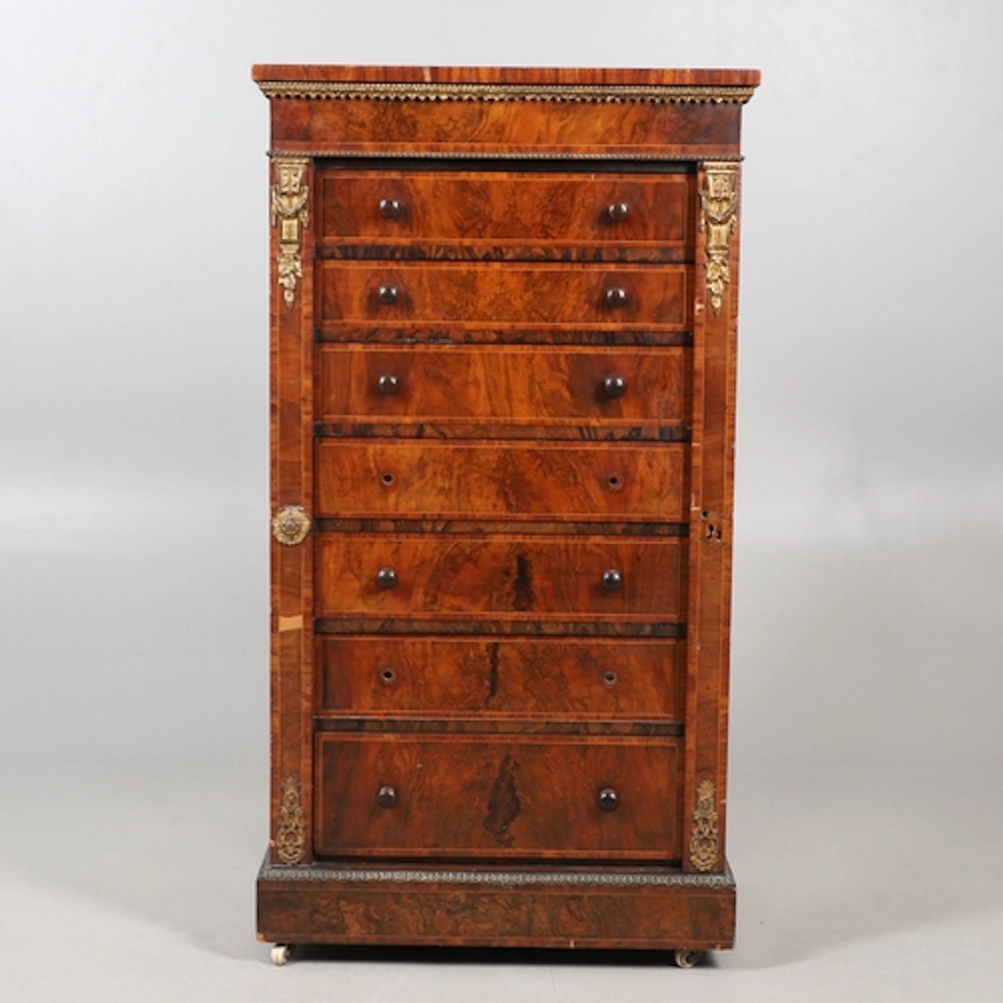 A LOUIS XVI STYLE FIGURED WALNUT WELLINGTON CHEST. 19th cent...