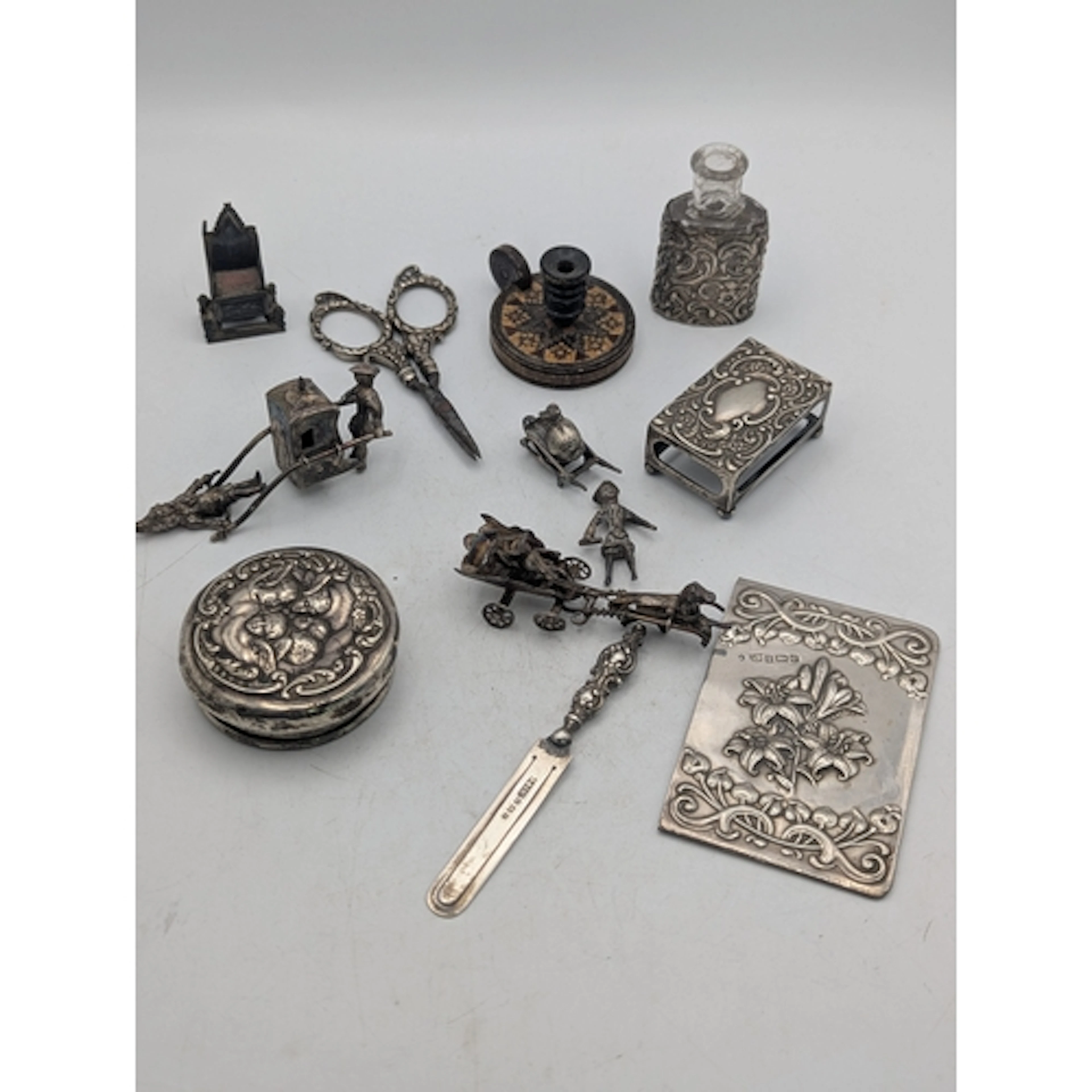 A group of silver items and collectables to include man pull...