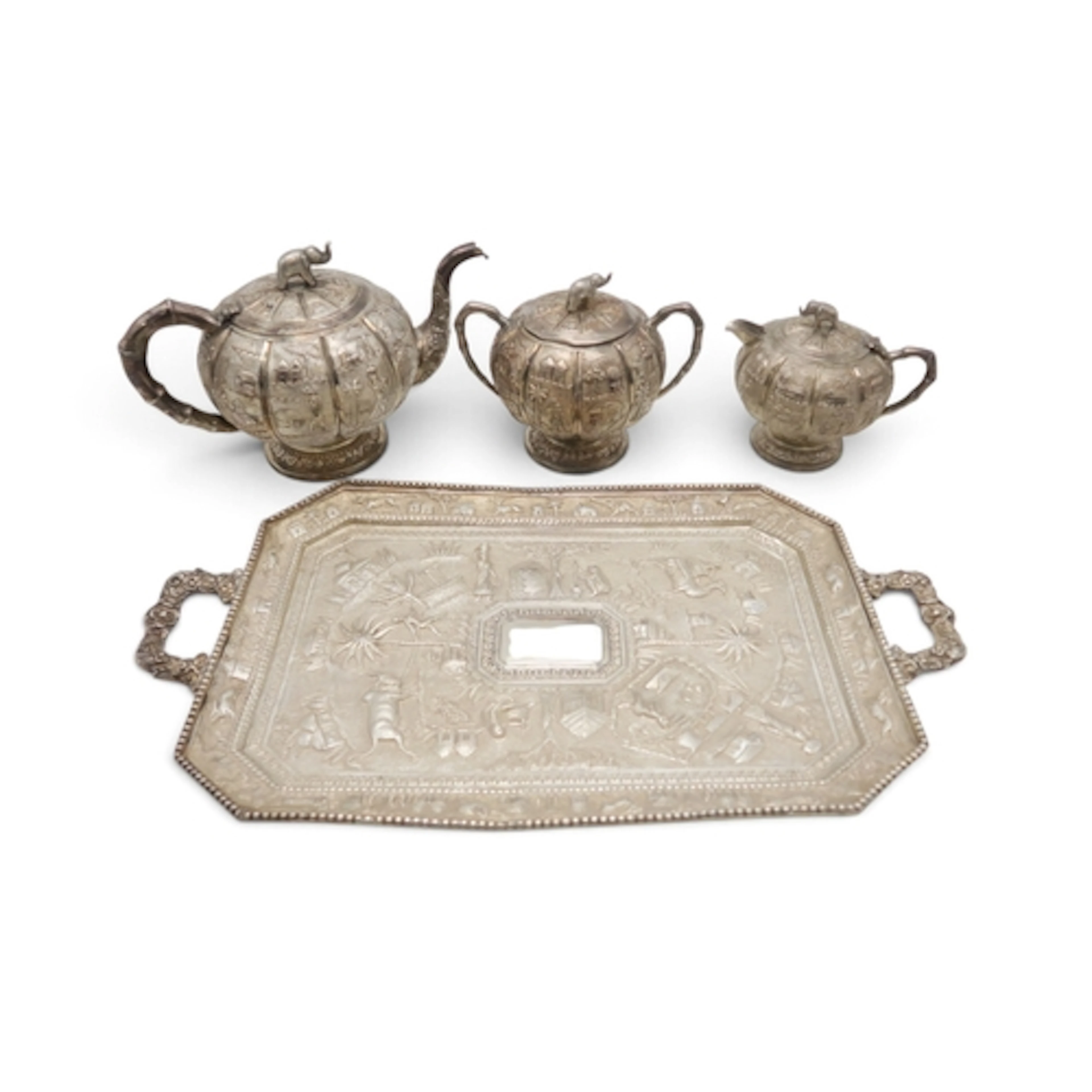 AN INDIAN FOUR PIECE SILVER TEA SERVICE of lobed spherical f...