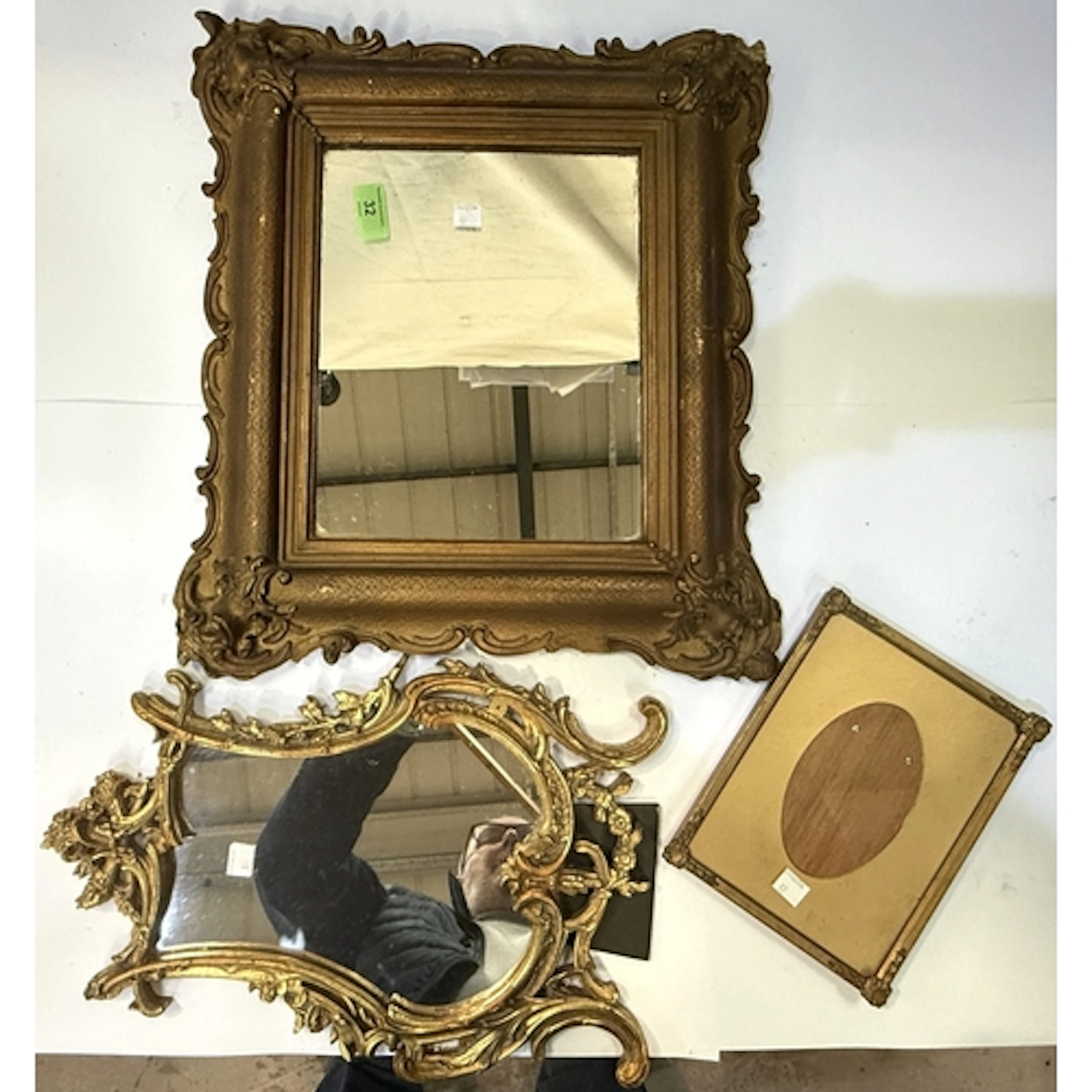 A small square gilt framed mirror; an ornate gilt metal free...