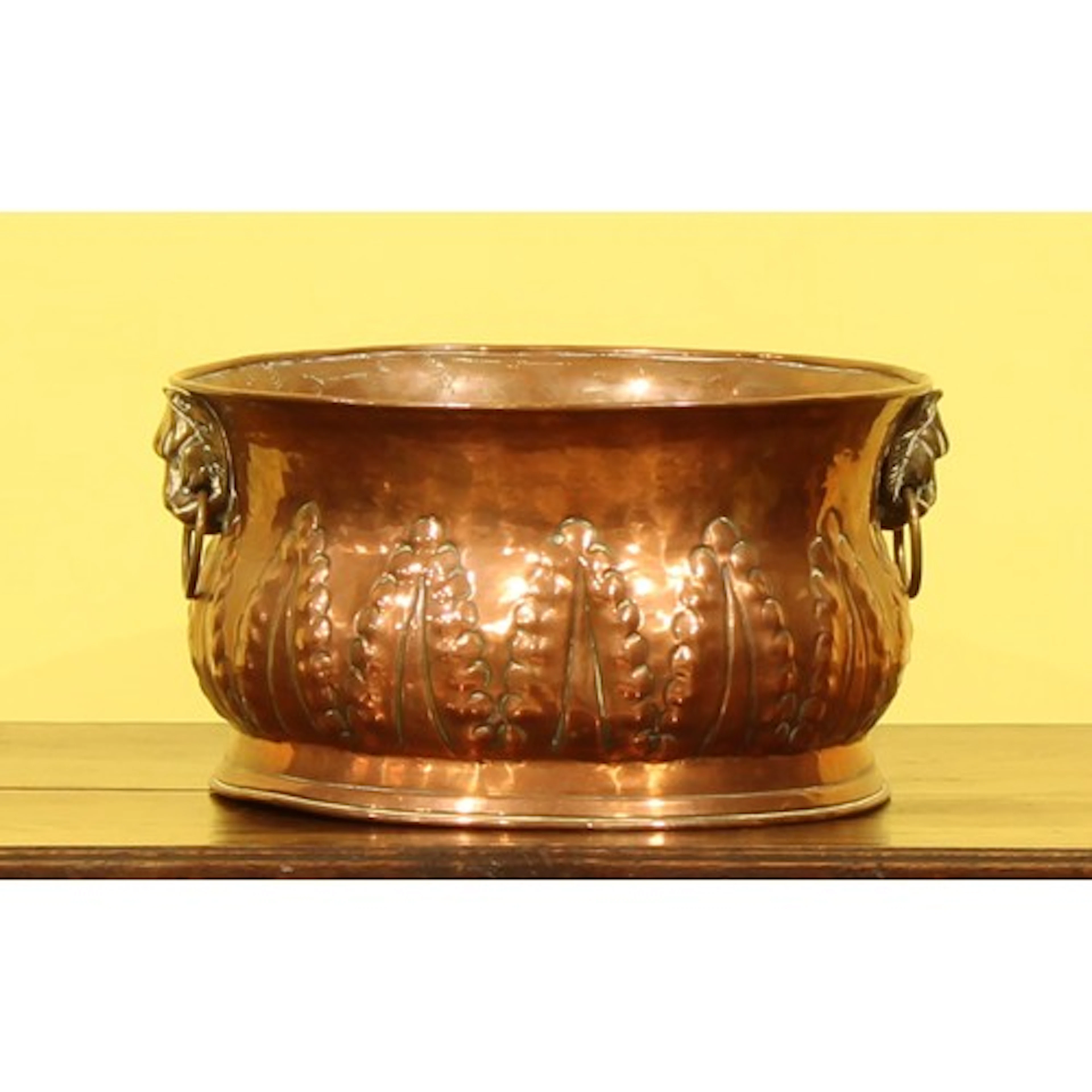 An Arts & Crafts copper two handled circular planter or jard...