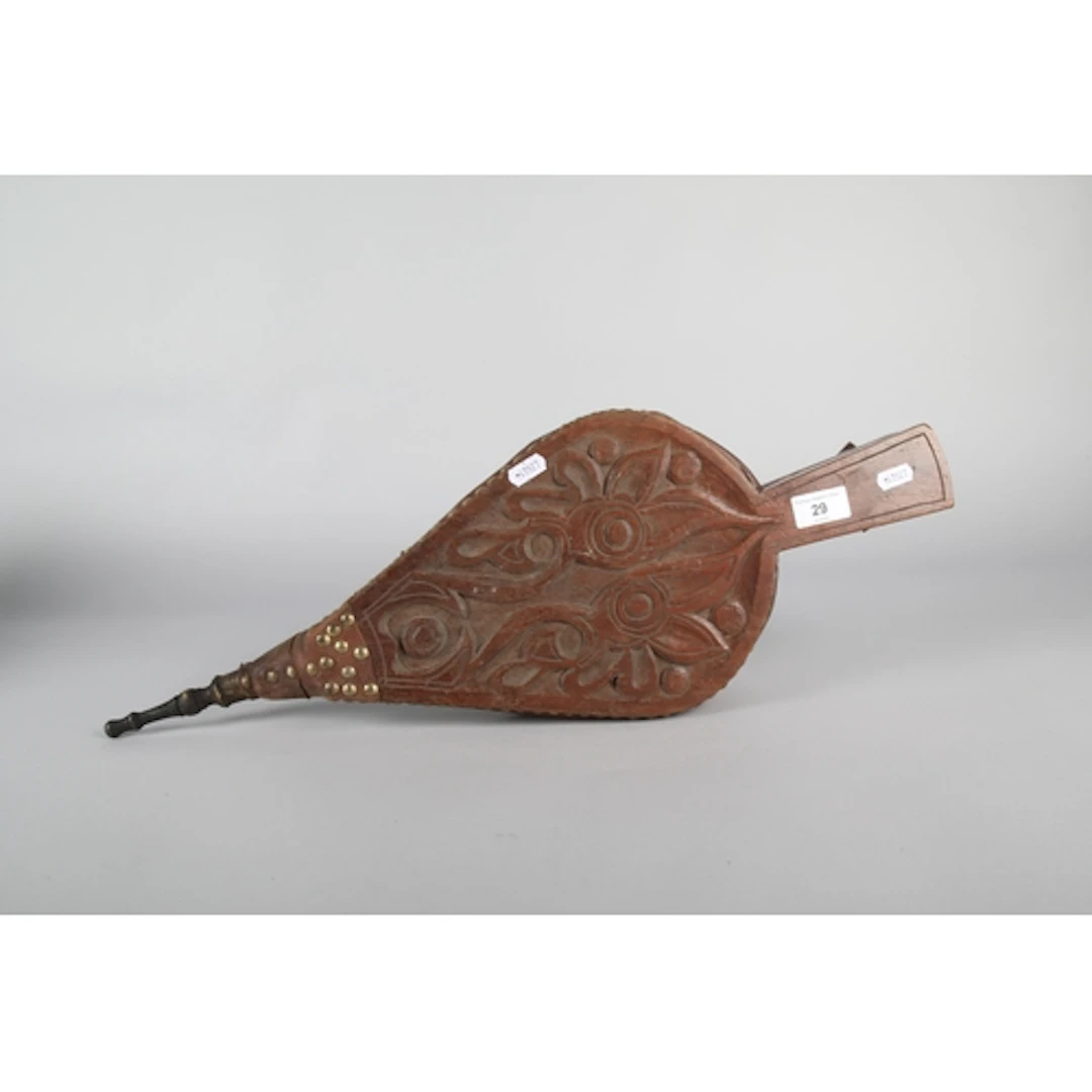 Carved wood and brass bellows.