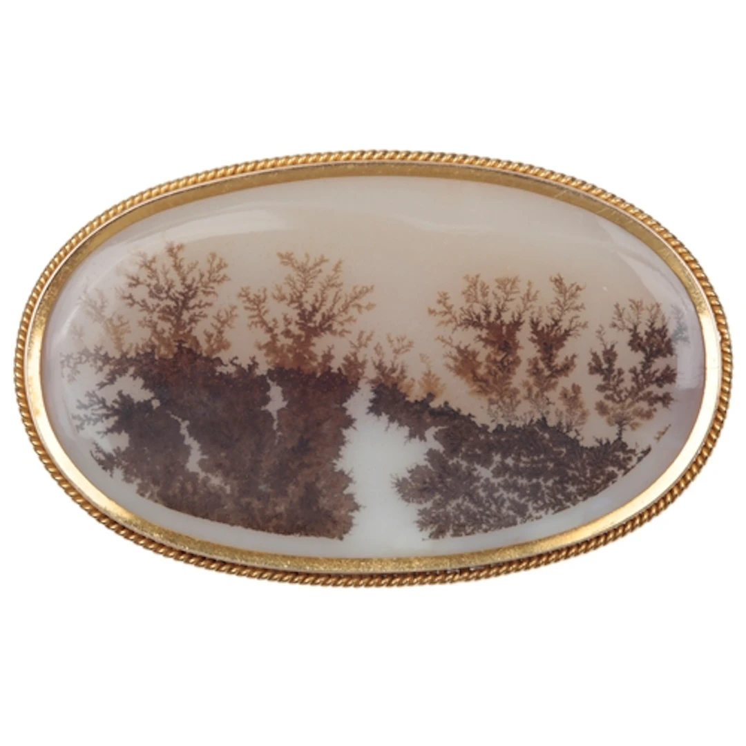 An agate brooch, late 19th century, set with a panel of dend...