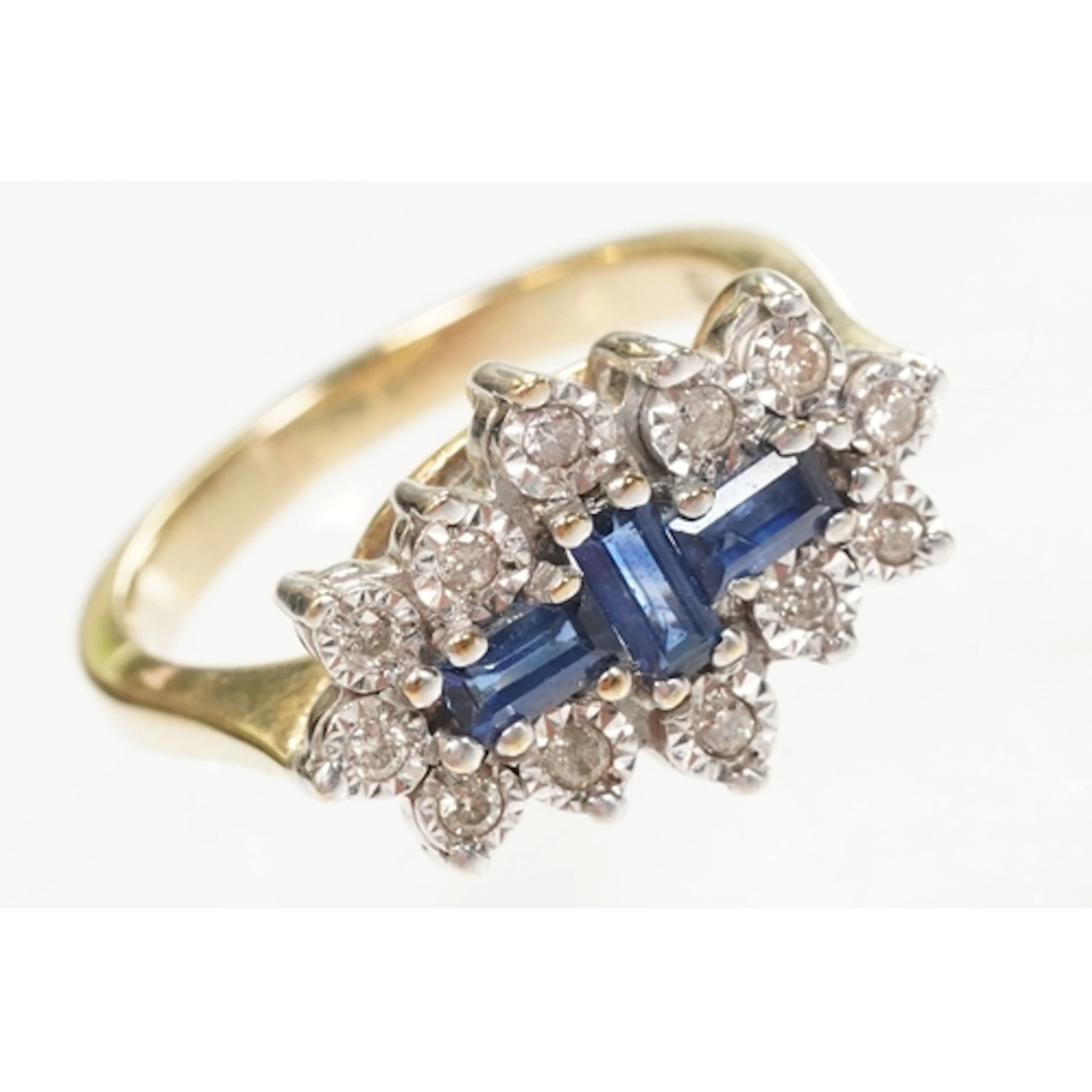 9ct gold, sapphire and diamond cluster ring. The ring being ...