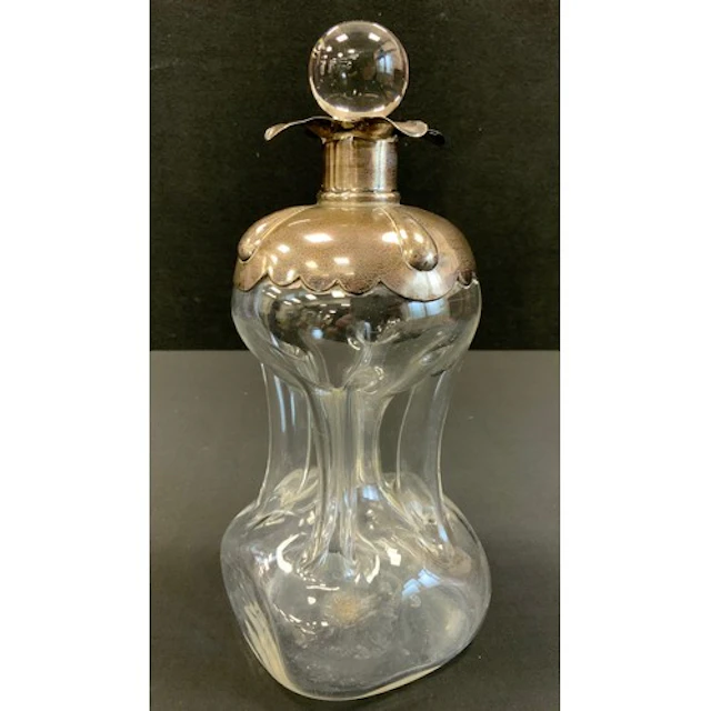 An Edwardian silver mounted ‘glug glug’ decanter, marks rubb...