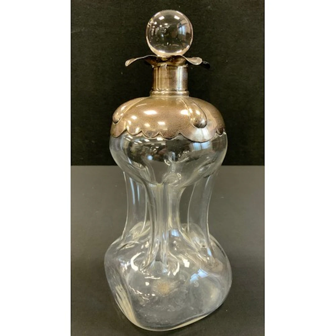 An Edwardian silver mounted ‘glug glug’ decanter, marks rubb...