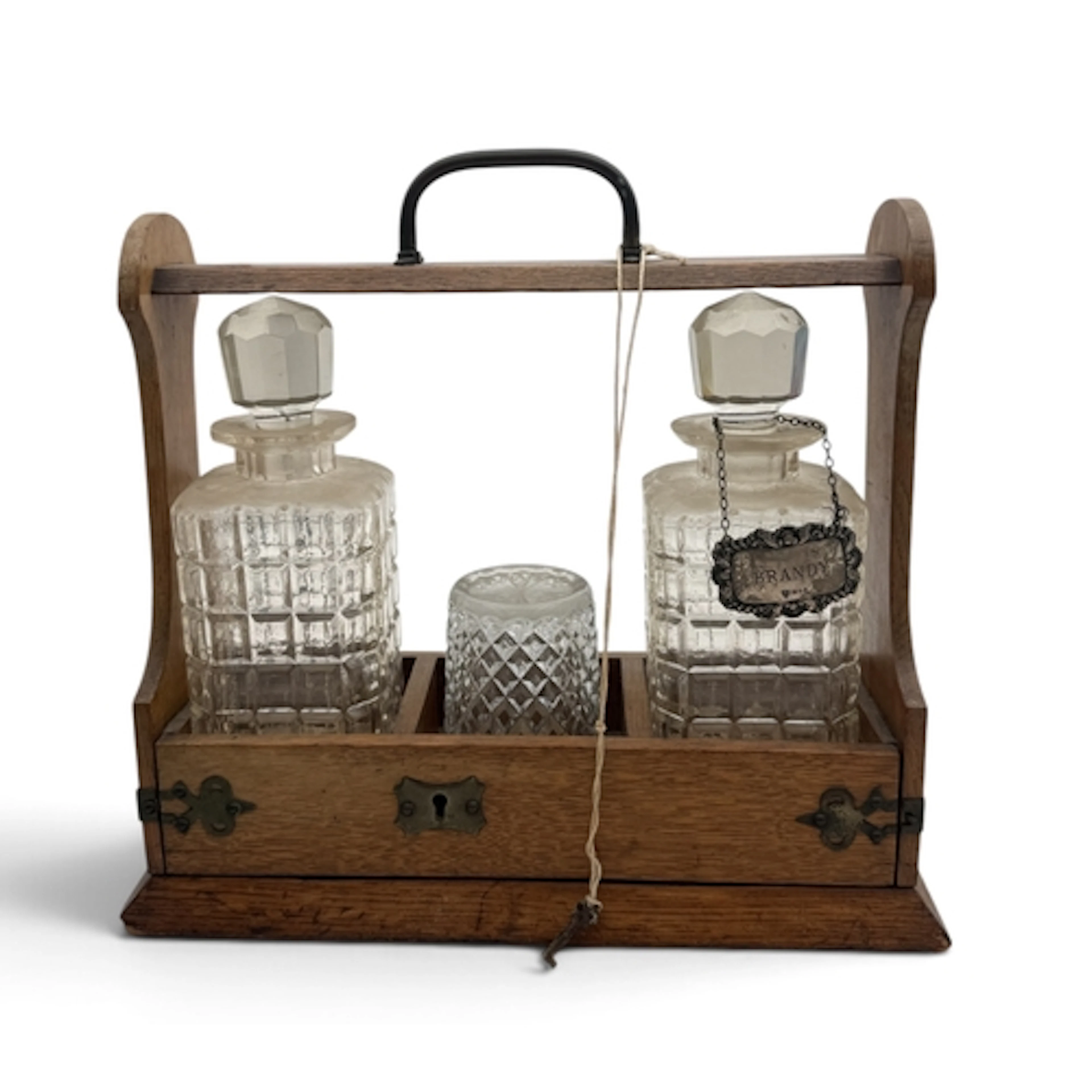 AN EDWARDIAN TANTALUS TOGETHER WITH SILVER WHISKEY LABEL...