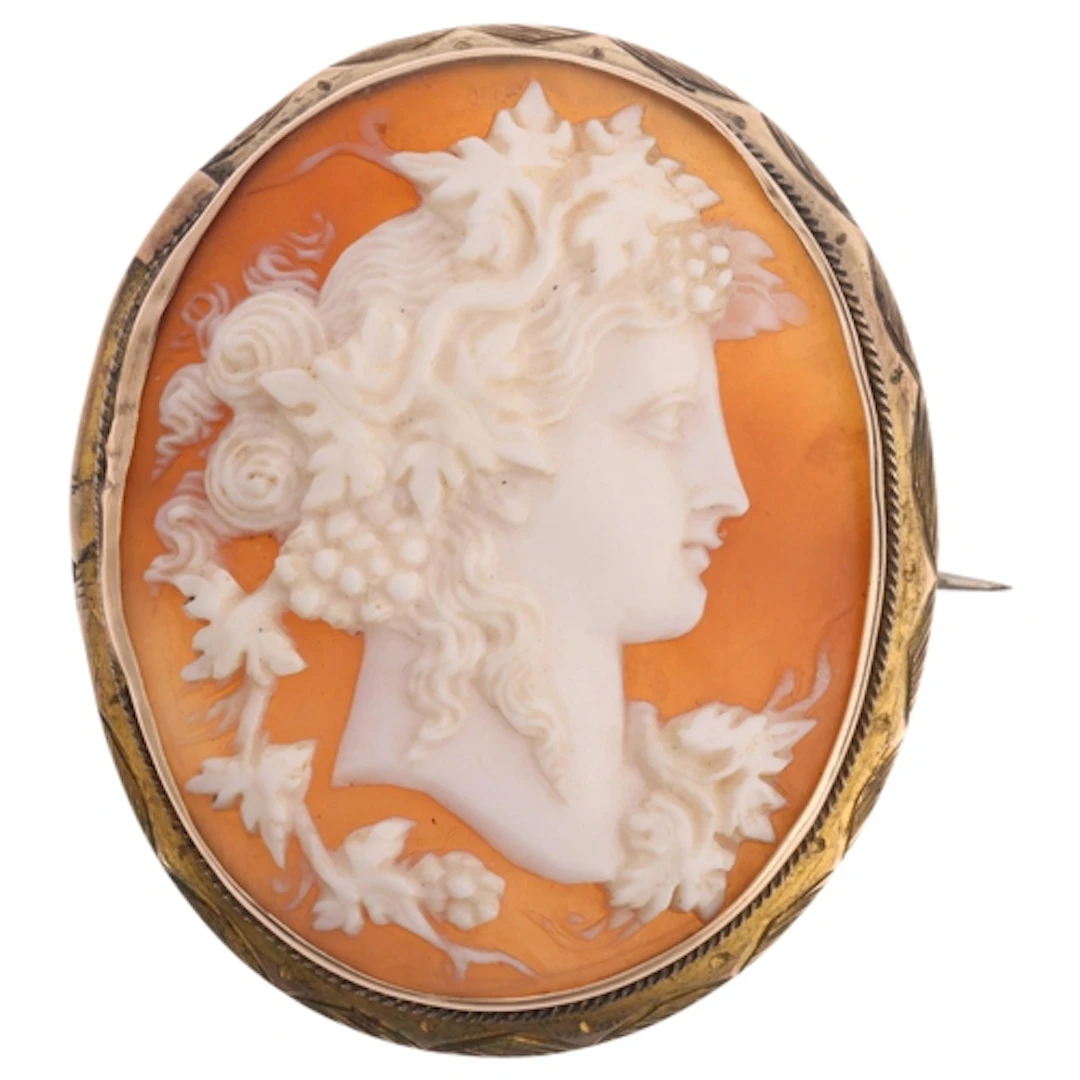 A 19th century shell cameo brooch, the oval panel relief car...
