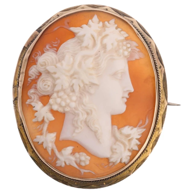 A 19th century shell cameo brooch, the oval panel relief car...