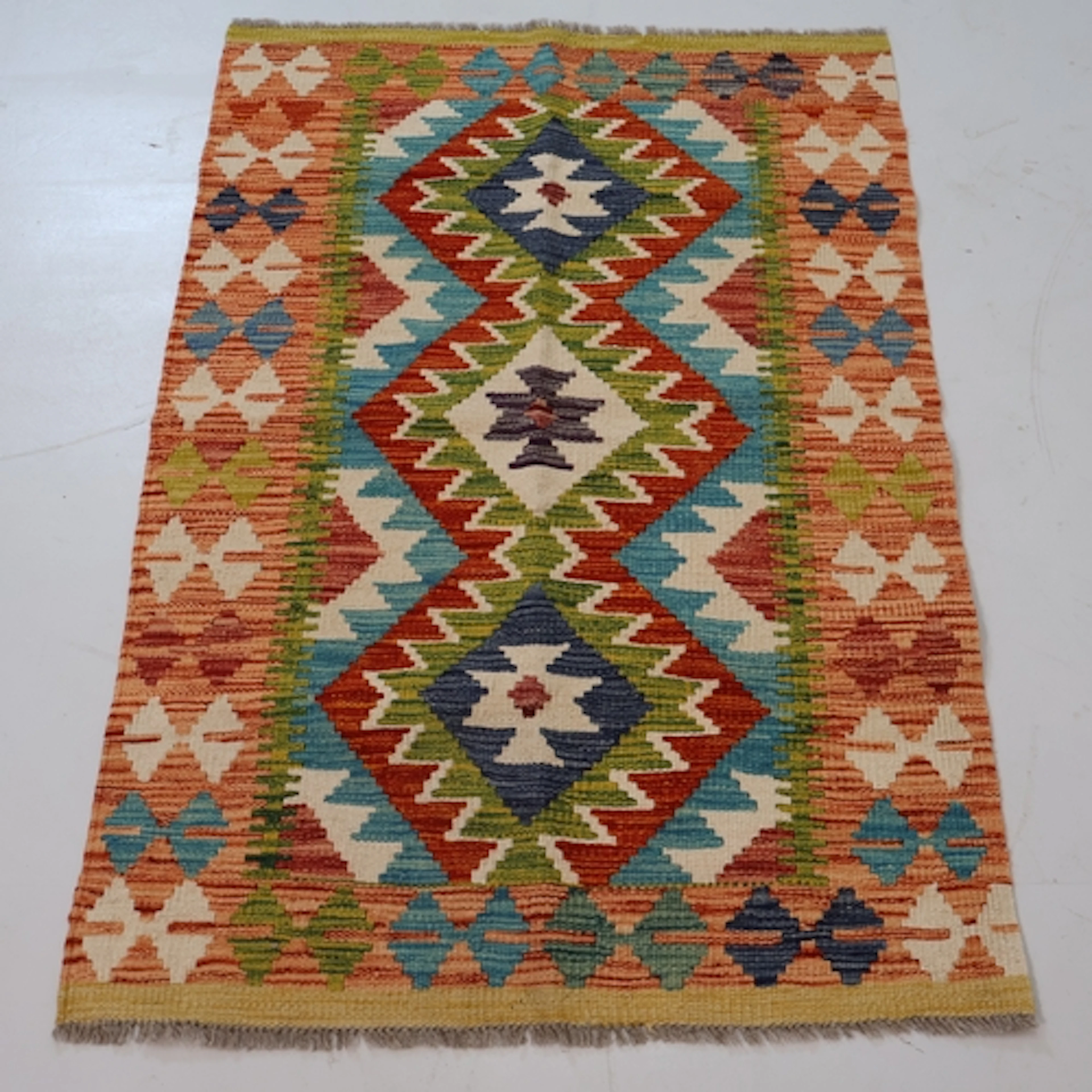A peach ground chobi kilim rug, L117cm, W81cm.