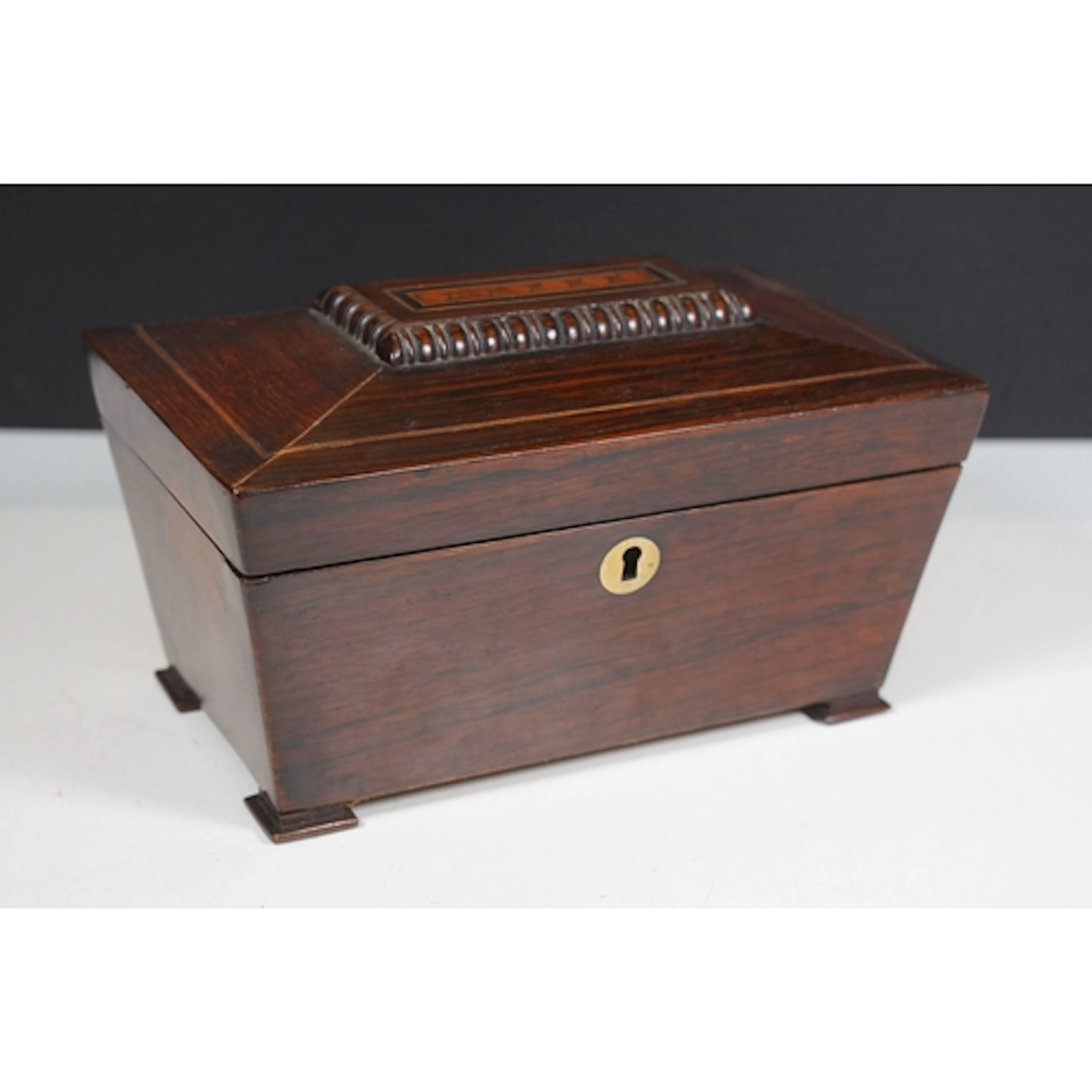 19th century rosewood tea caddy of sarcophagus form, lid hav...