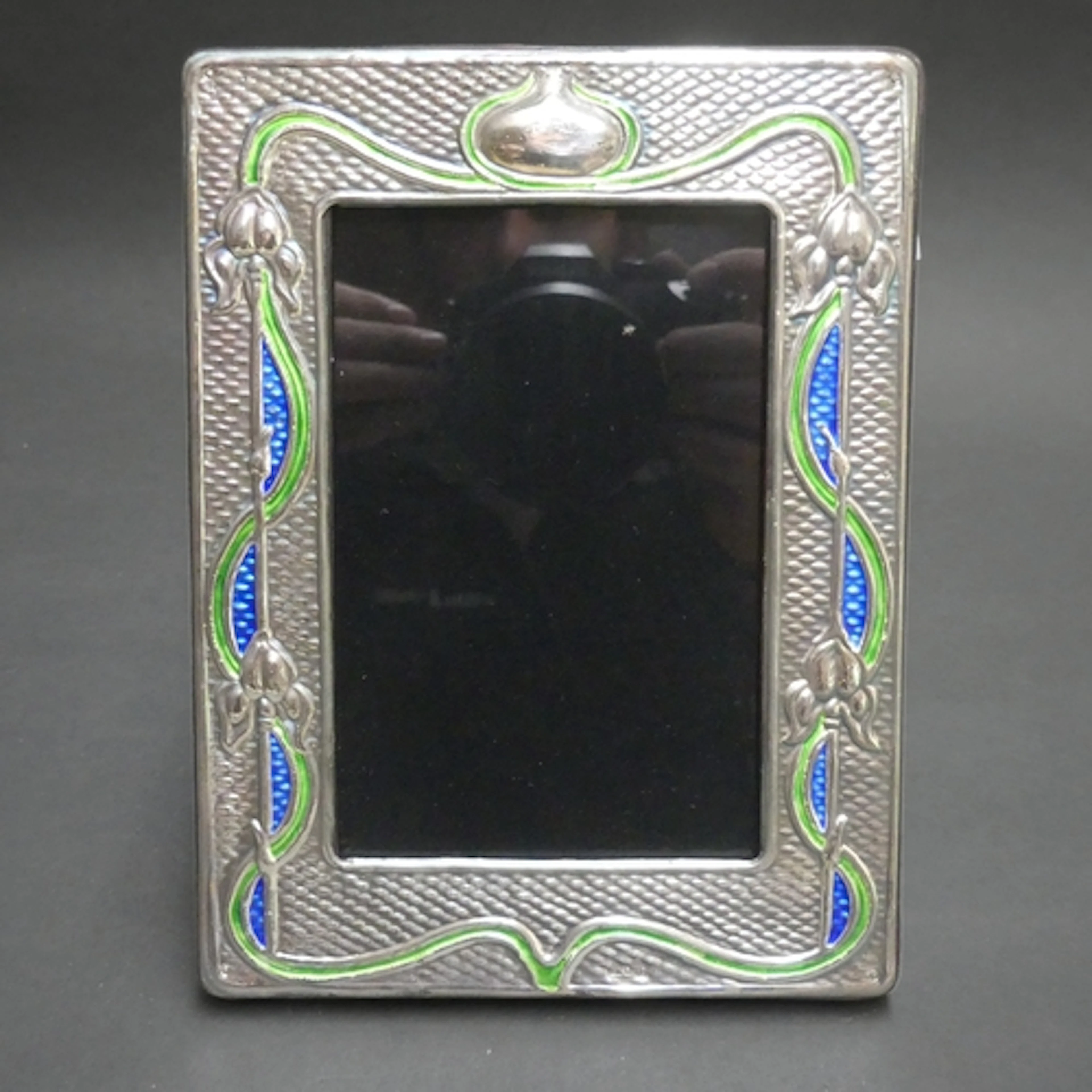 An Art Nouveau design silver and enamel fronted photo frame,...
