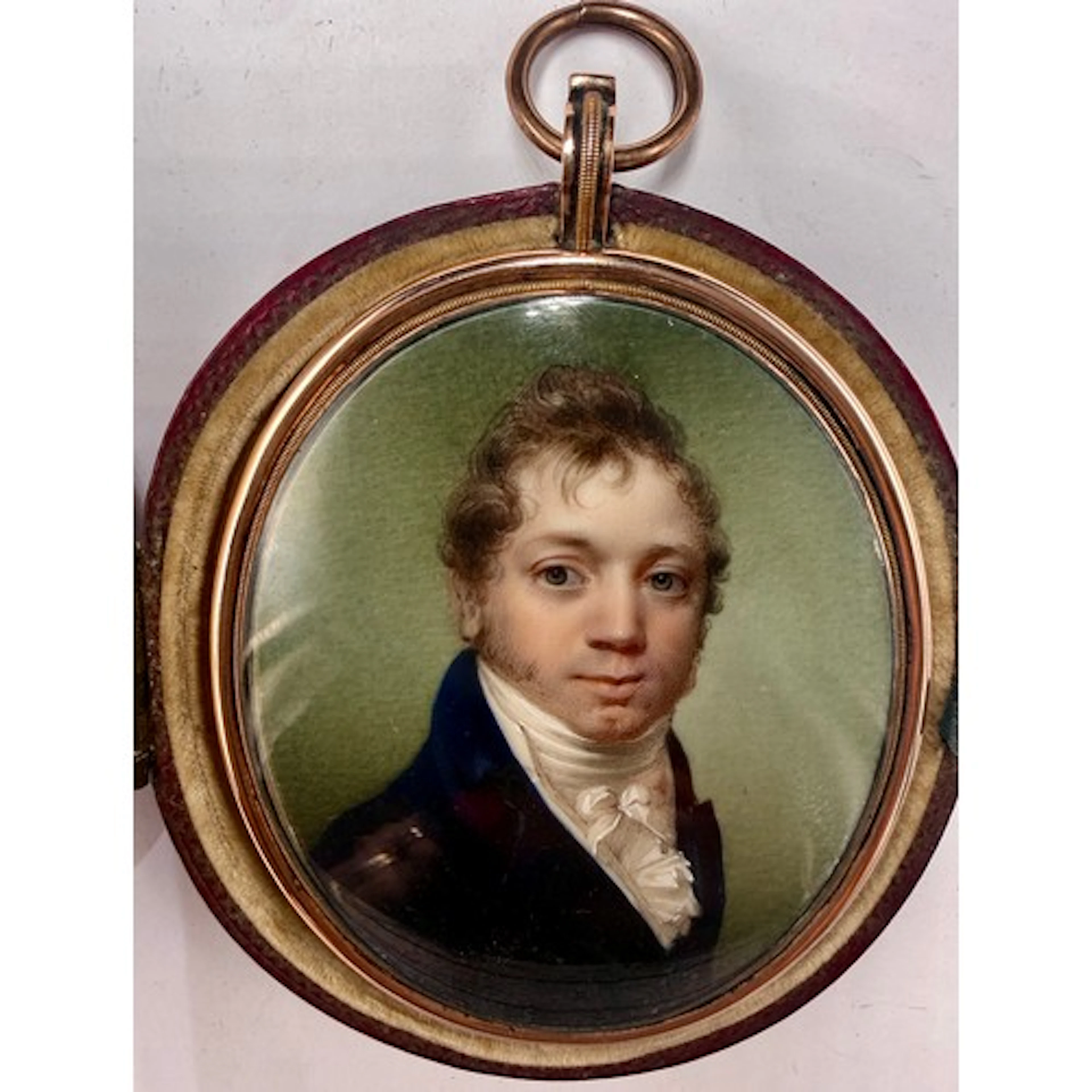 An oval portrait miniature on ivory of a gentleman with a wh...