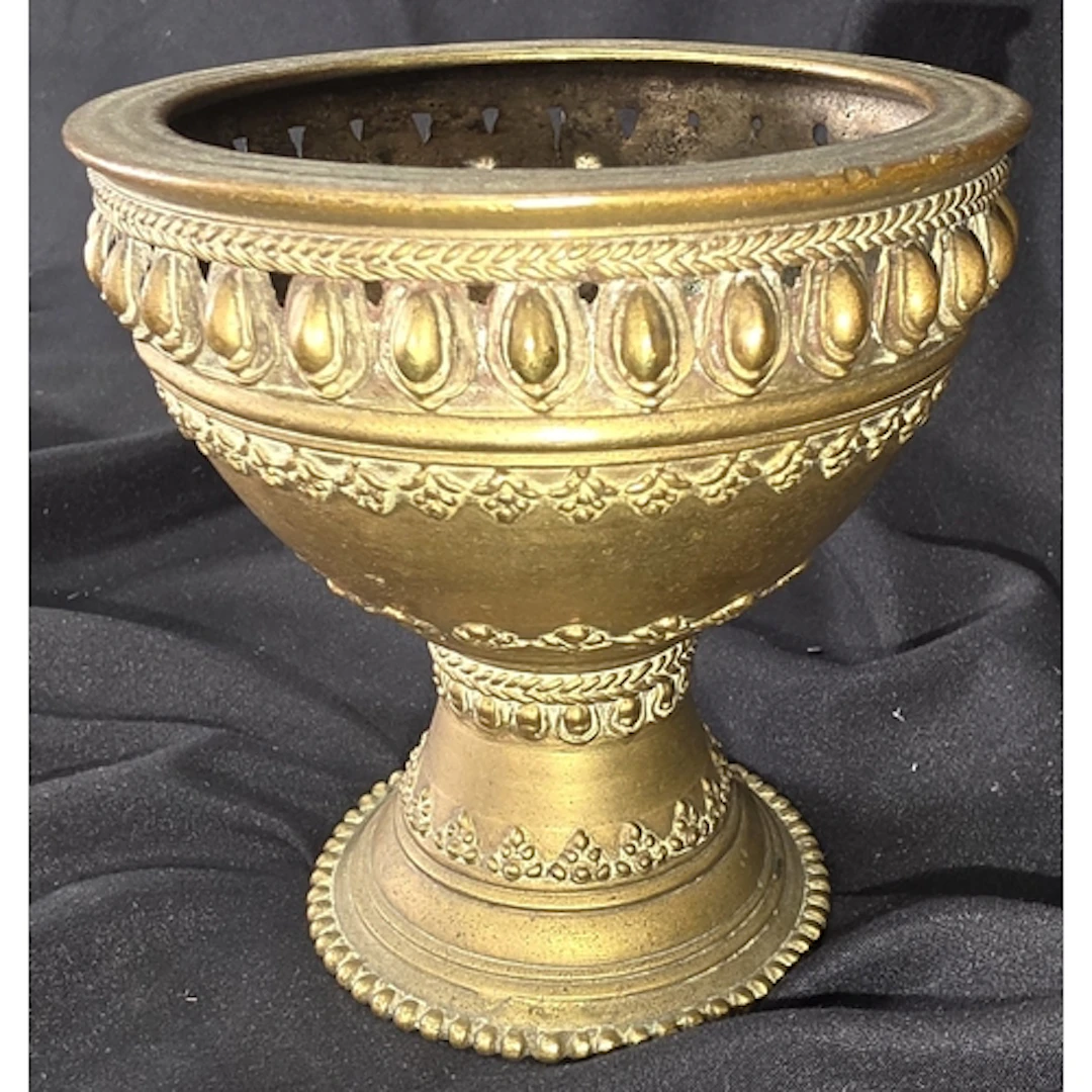A Tibetan Buddhist brass goblet with embossed detail, height...