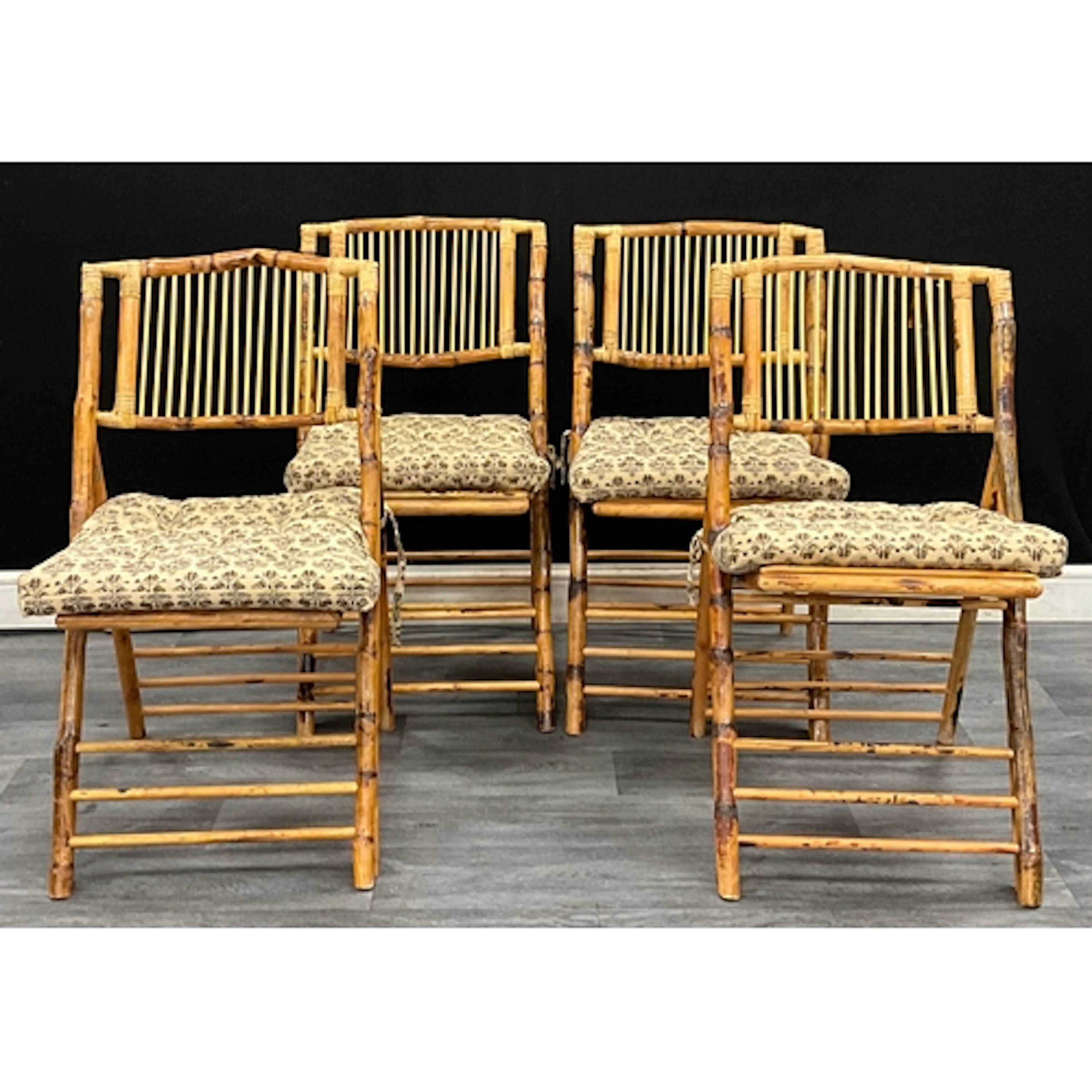 A set of four faux bamboo folding chairs with Madam Stolz se...