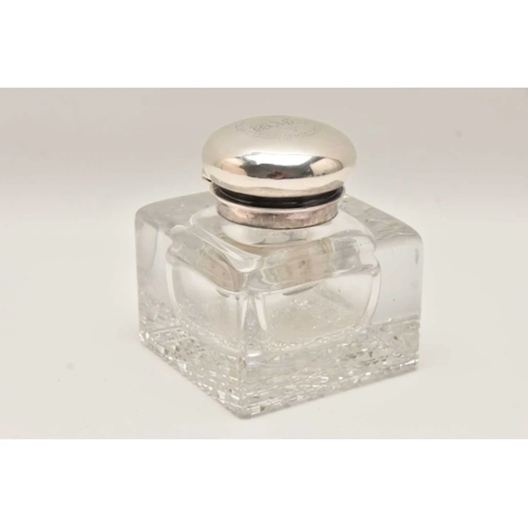 A HEAVY CUT GLASS AND SILVER MOUNTED INK WELL, of a square f...