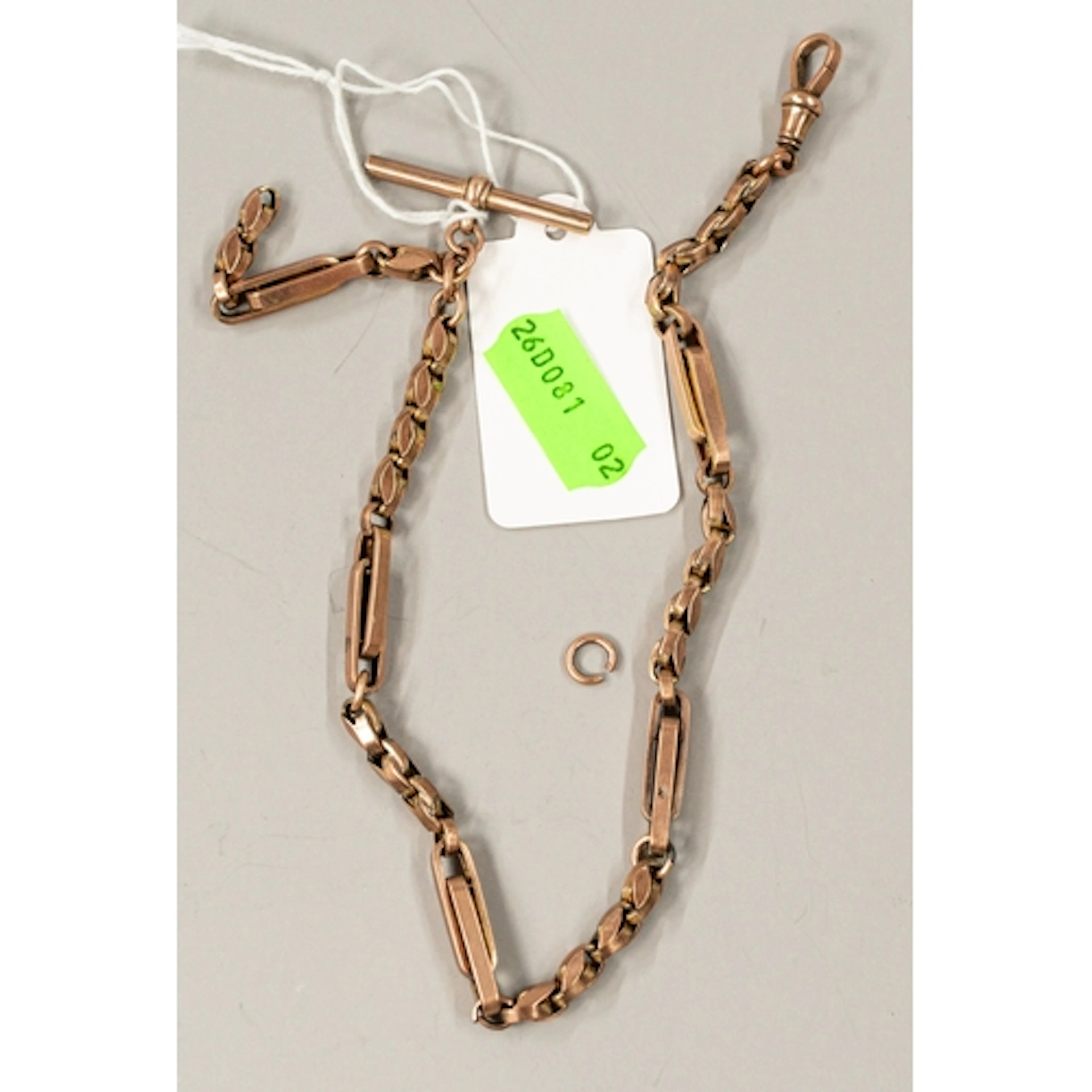 Jewellery: a 9ct rose gold trombone link Albert chain with d...