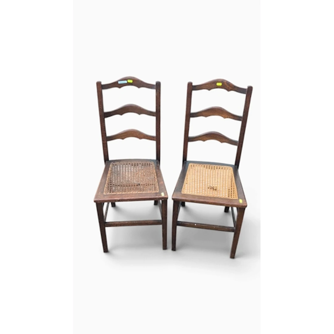A pair of oak ladder-back dining chairs, each with three sha...