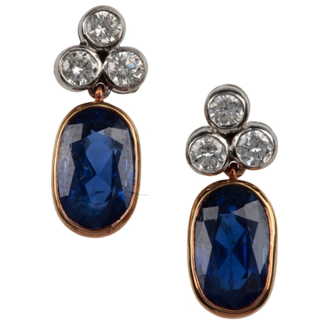 A pair of sapphire and diamond earrings, composed of oval sa...