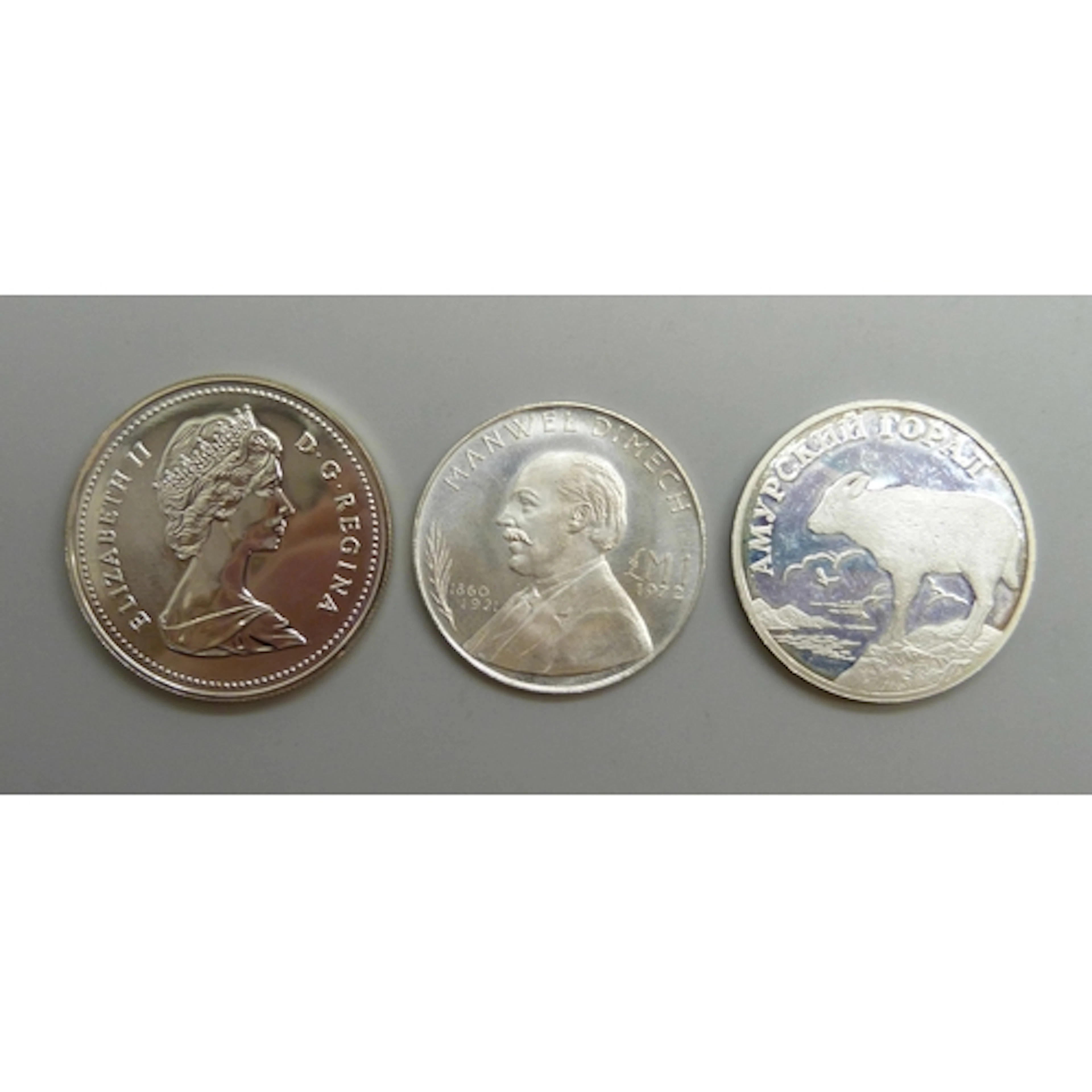 Silver coins - a Russian 1 ruble, a Maltese 1 lira, and a Ca...