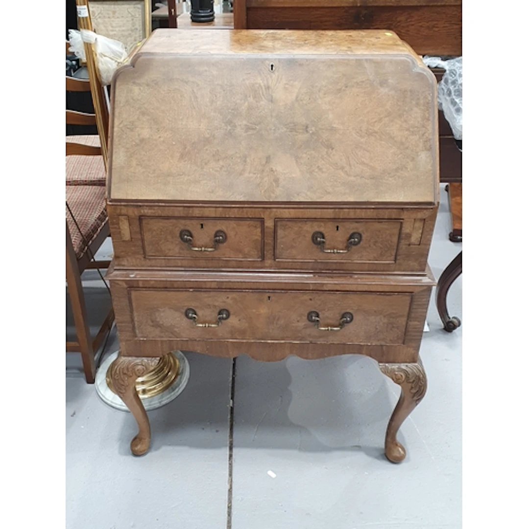 A walnut Bureau fitted two short over one long drawer raised...