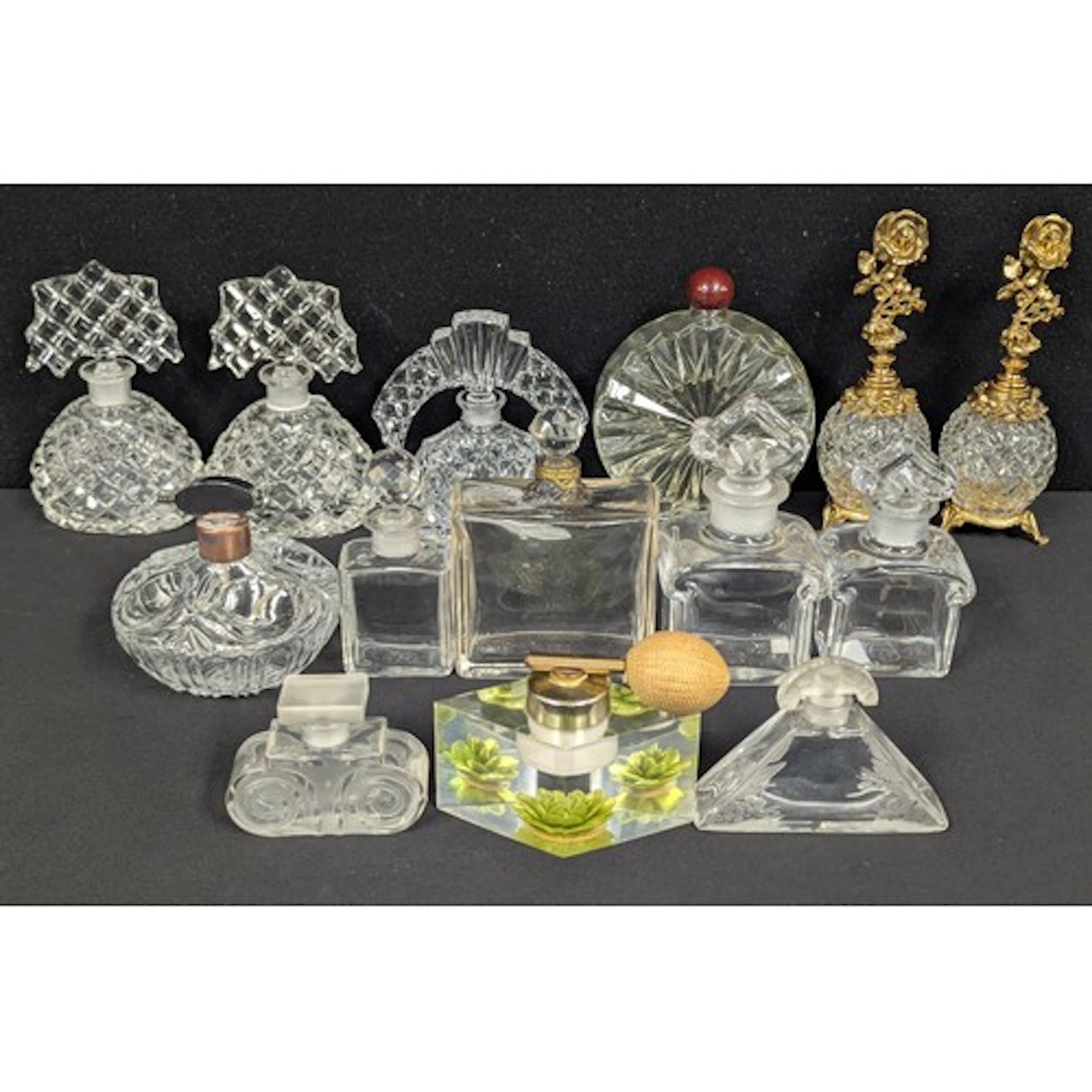 A collection of fourteen glass perfume bottles including a n...