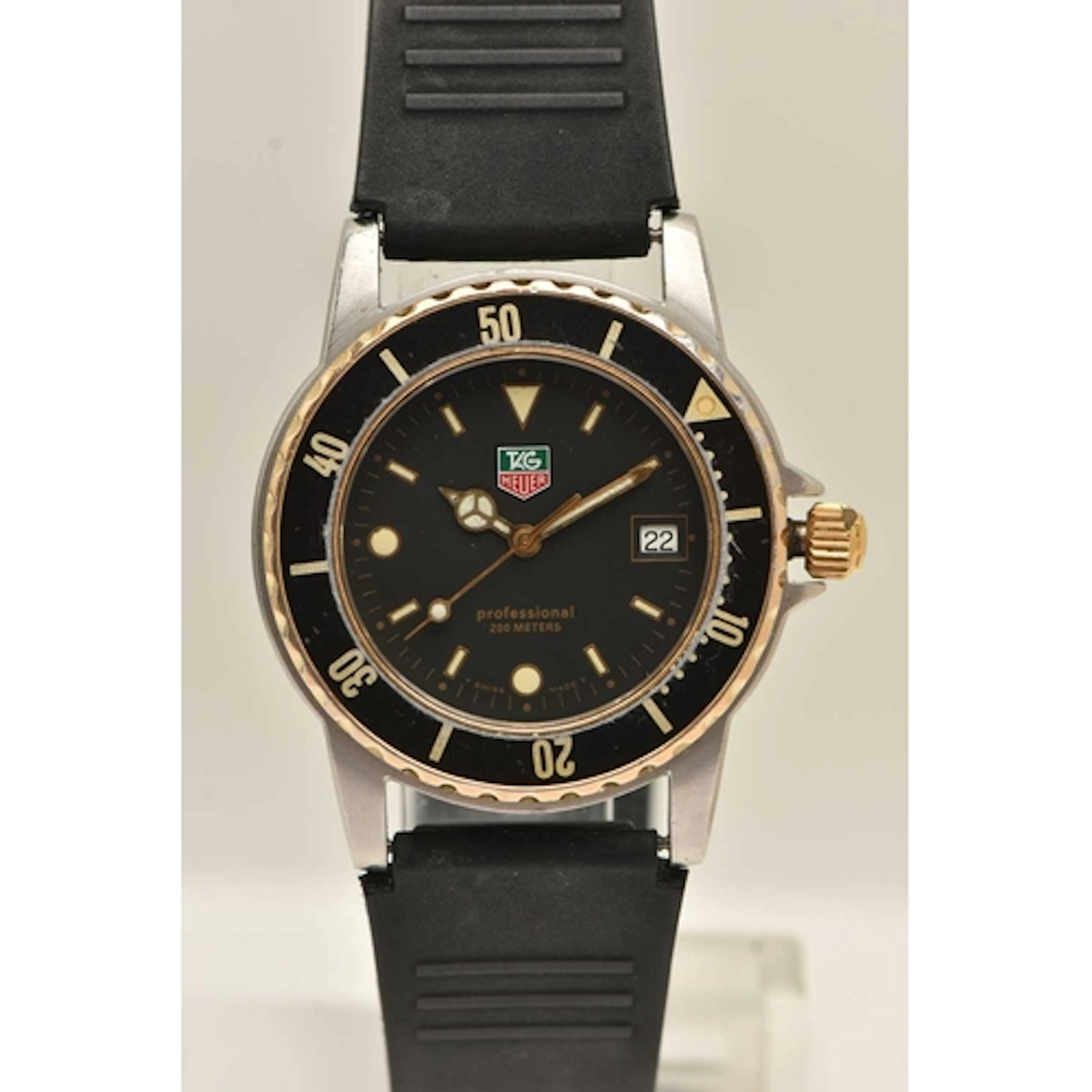 A 'TAG HEUER' WRISTWATCH, quartz movement, round black dial ...