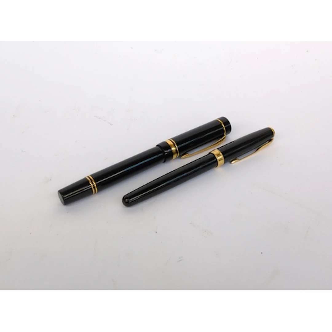 A Parker Sonnet fountain pen, together with a further, large...