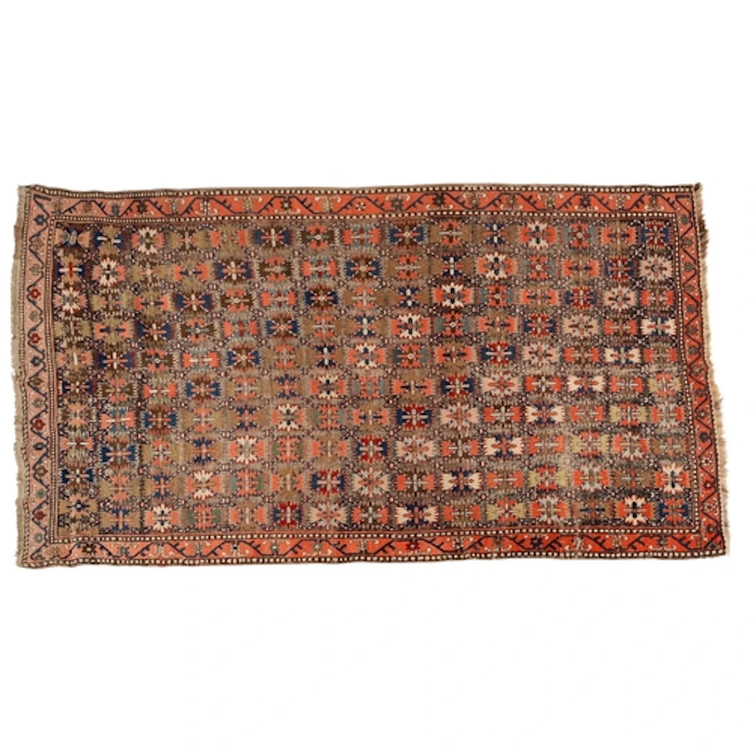 A Joshegan rug, the lozenge panel field with an all over des...