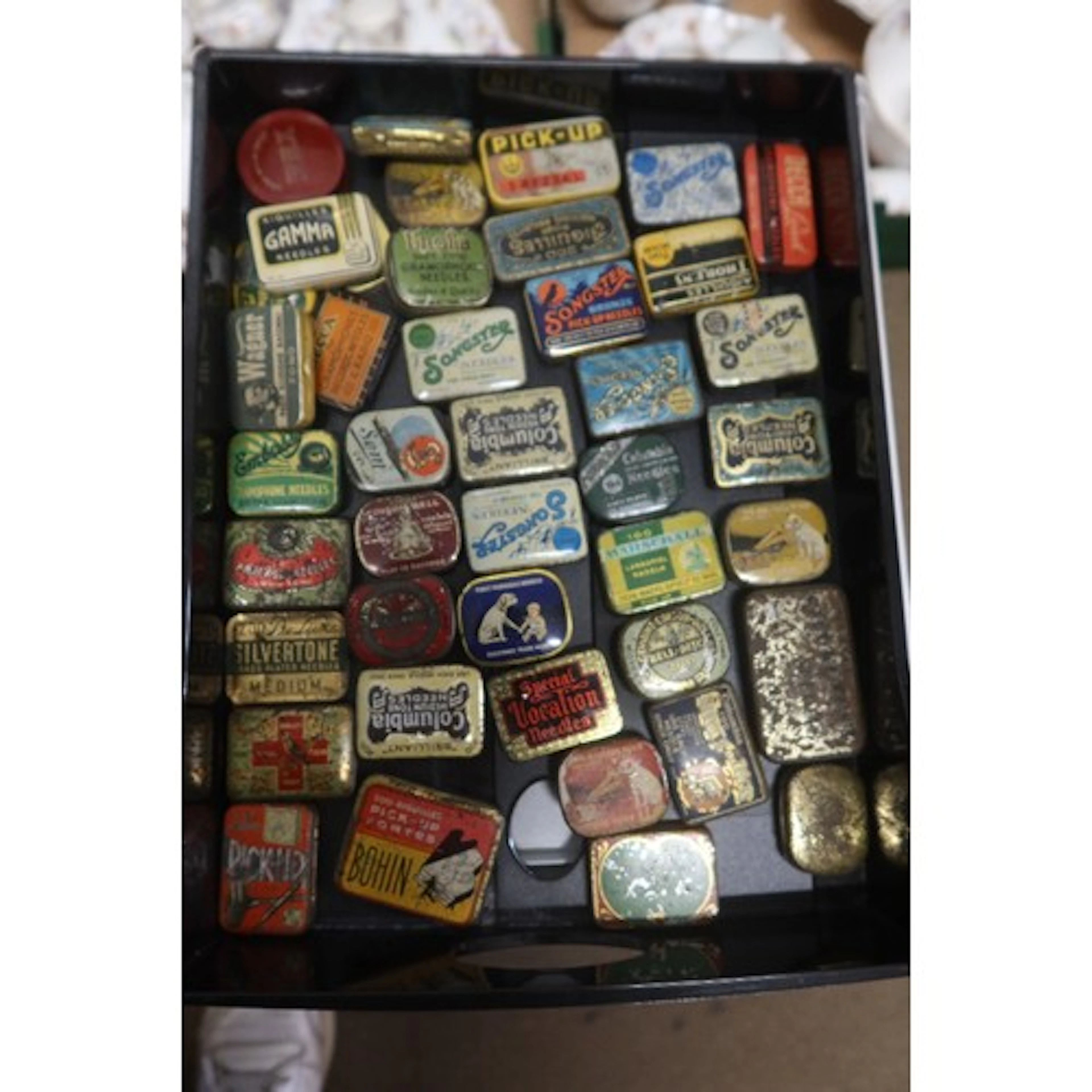 A tray of vintage gramphone needle tins