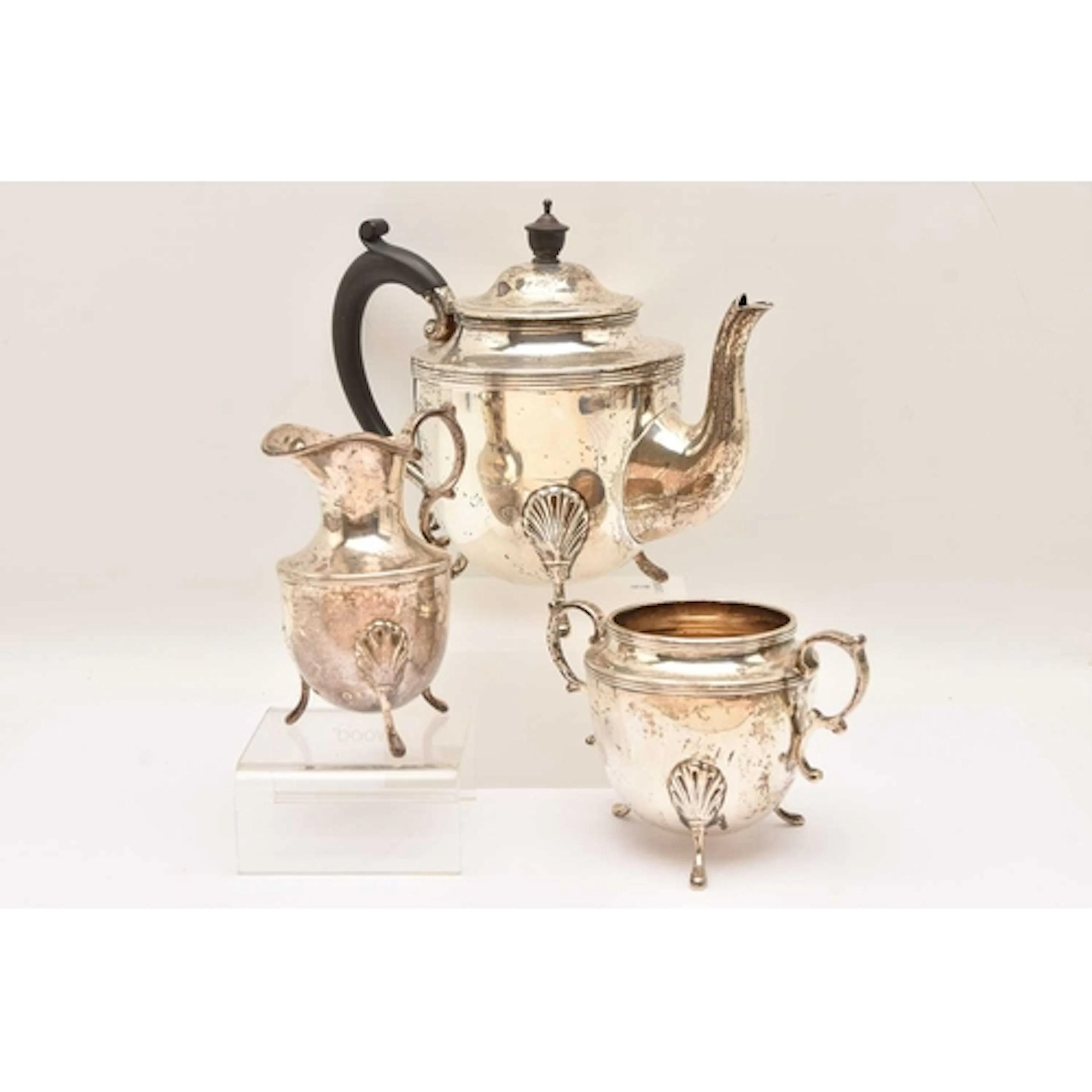 AN EARLY 20TH CENTURY SILVER THREE PIECE TEA SET, comprising...