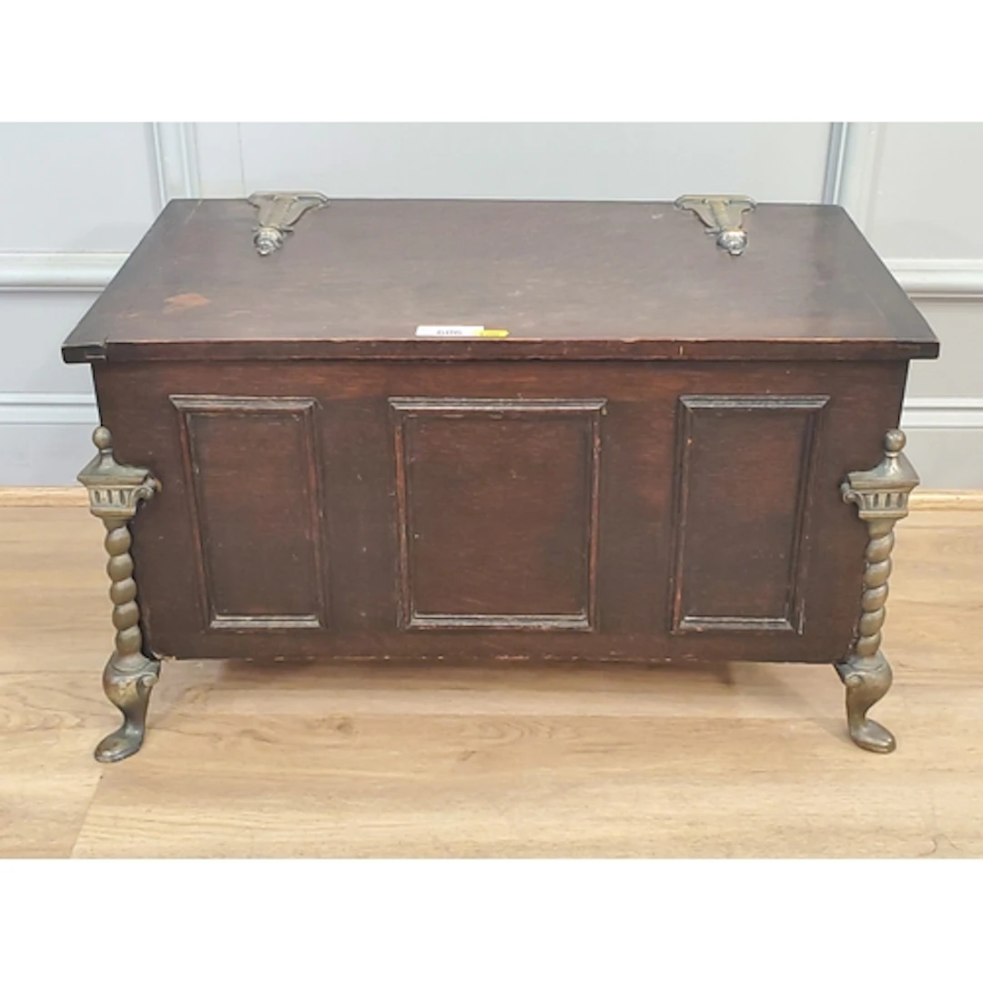 An small oak Chest featuring brass shaped feet and hinges, (...